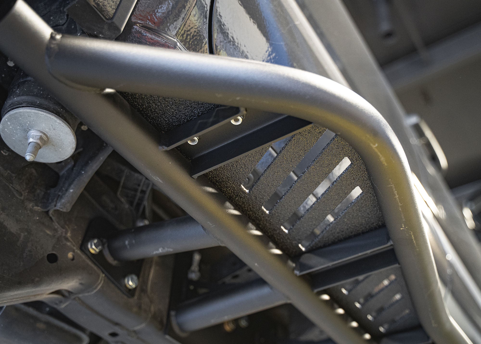 Close up of the mounting hardware and brakes for bolt-on installation of the 2024+ Toyota Tacoma Rock Sliders from Backwoods Adventure Mods