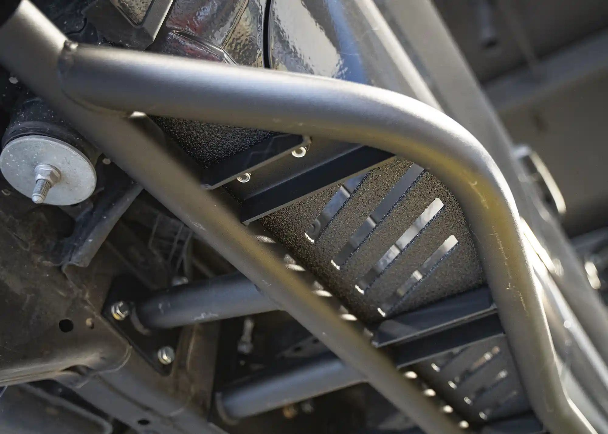 Close up of the mounting hardware and brakes for bolt-on installation of the 2024+ Toyota Tacoma Rock Sliders from Backwoods Adventure Mods