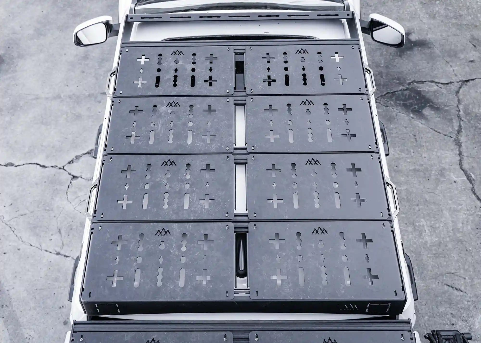 Top down view of Backwoods Adventure Mods DRIFTR roof rack on a white 2024 4th gen Toyota Tacoma with modular cargo deck panels installed