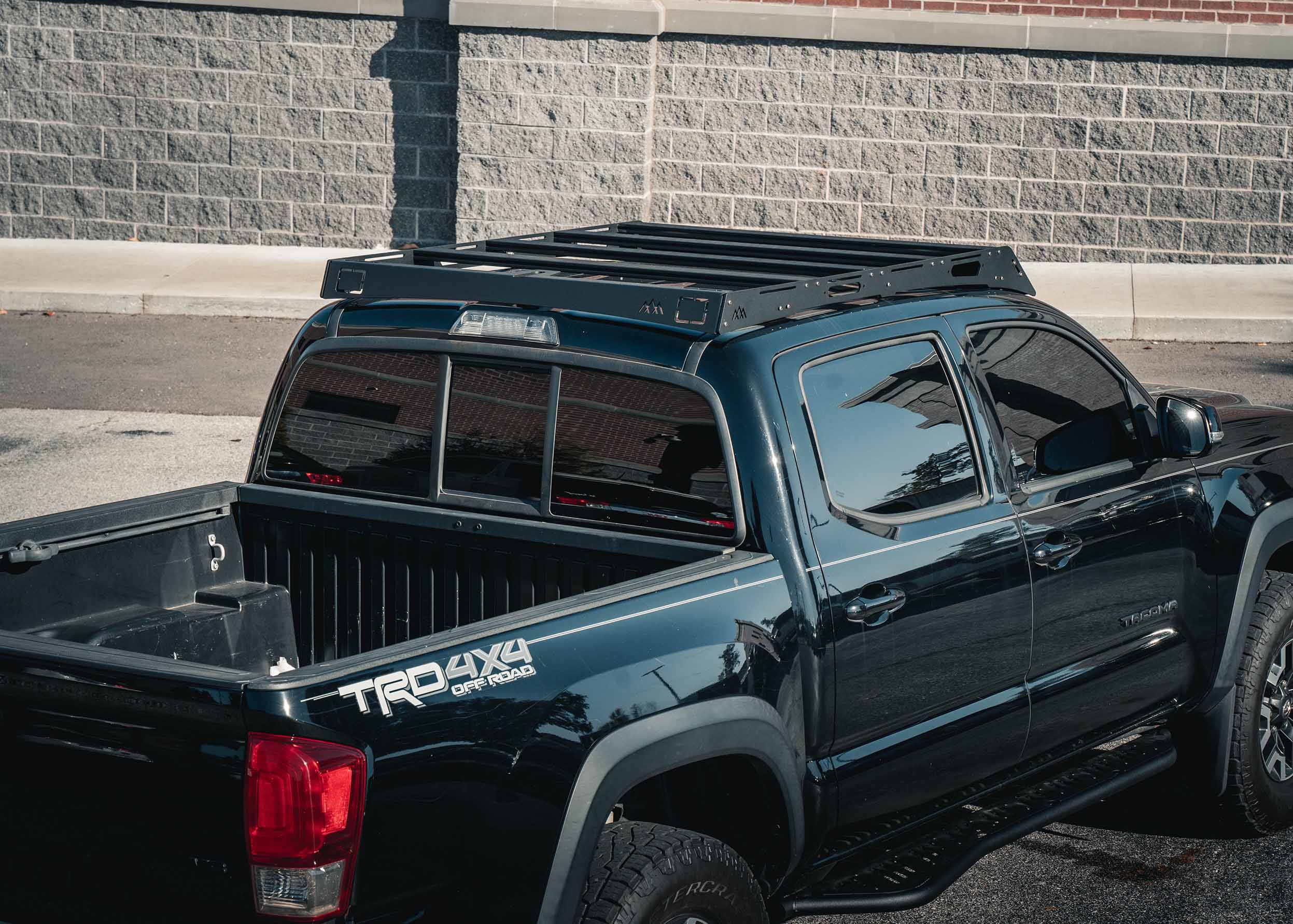 Backwoods Adventure Mods 2005-2023 2nd and 3rd Gen Toyota Tacoma DRIFTR Roof Rack cargo carrier installed on a black Tacoma pickup