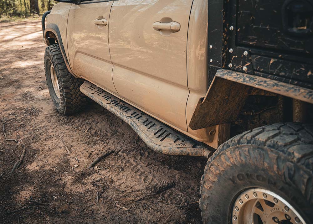 Backwoods Adventure Mods 2005-2023 2nd and 3rd Gen Toyota Tacoma Rock Sliders being used while off roading