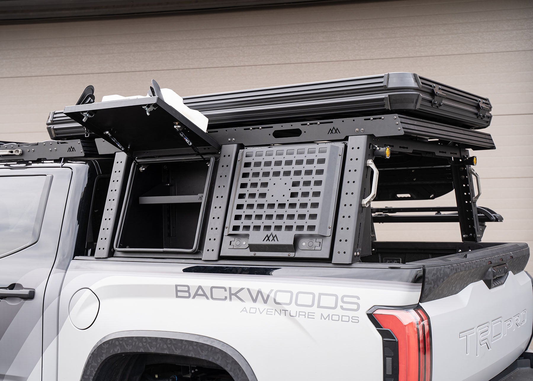 Backwoods Adventure Mods overland truck bed rack system installed on a 3rd gen Toyota Tundra with cargo box open