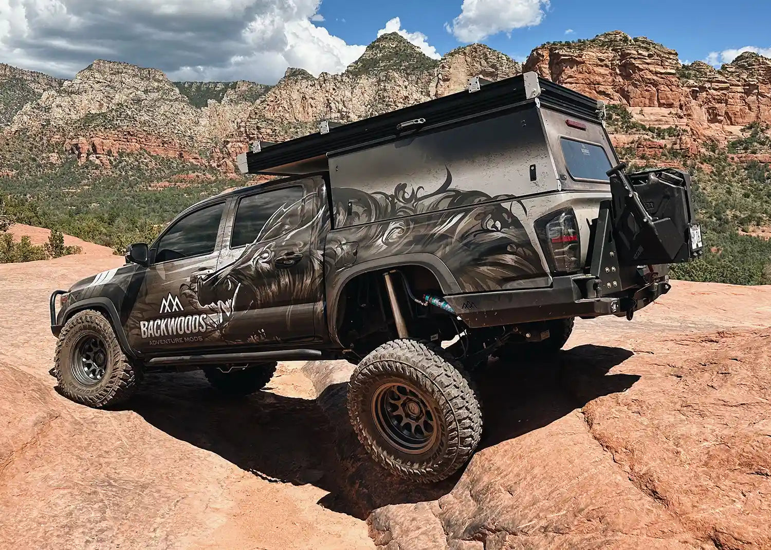 Backwoods Adventure Mods 2016-2023 Toyota Tacoma Hi-Lite High Clearance Dual Swing Out Rear Bumper installed on a 3rd Gen Tacoma rock crawling off road in Utah