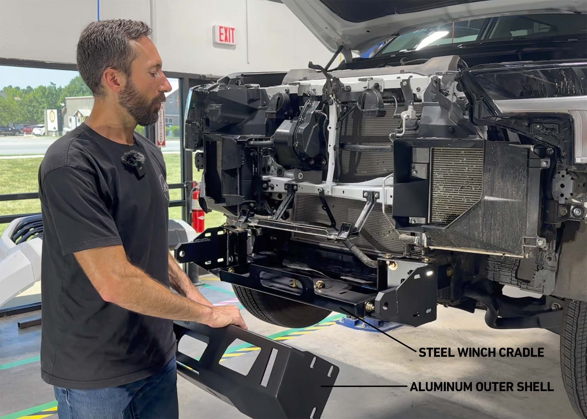 Image showing a man installing the Backwoods Adventure Mods 2022 2023 2024 2025 3rd Gen Tundra Front Bumper on a new Toyota Tundra and how the bumper components are assembled