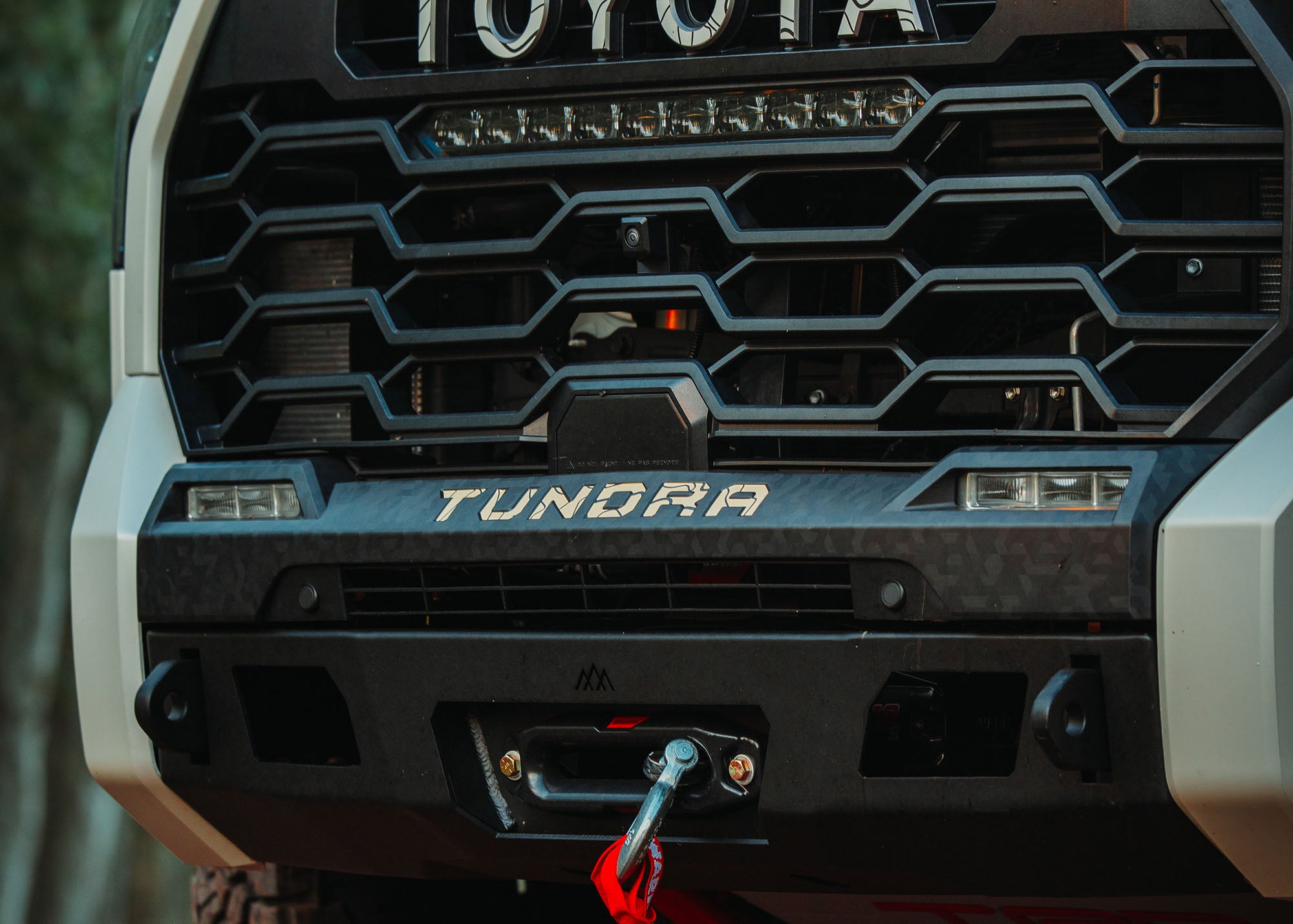 Close-up of the Backwoods Adventure Mods 2022 2023 2024 2025 3rd Gen Tundra Front Bumper with winch installed