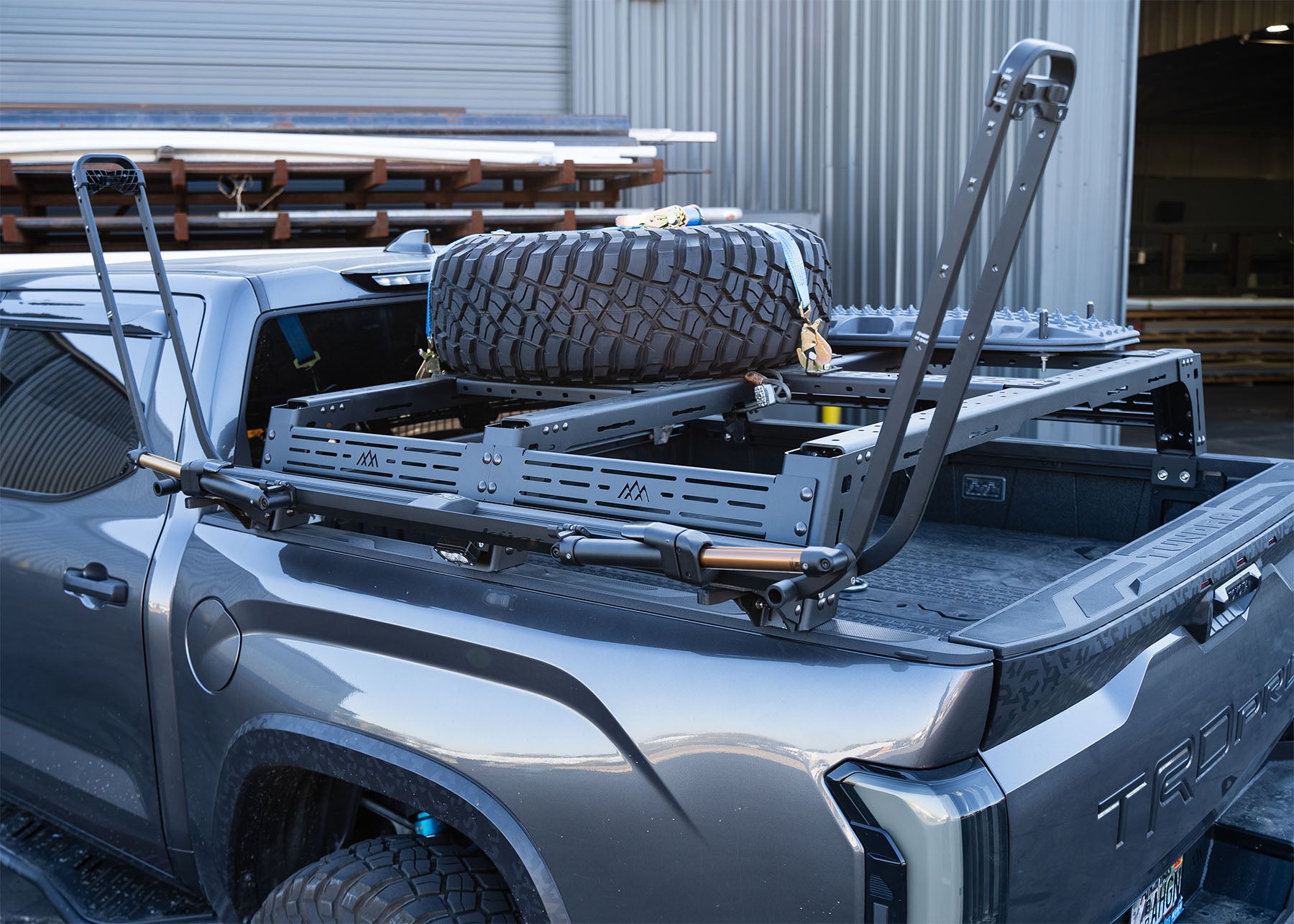 Backwoods Adventure Mods 3rd Gen Toyota Tundra mid-height Bed Rack installed with accessories and spare tire mounted on top