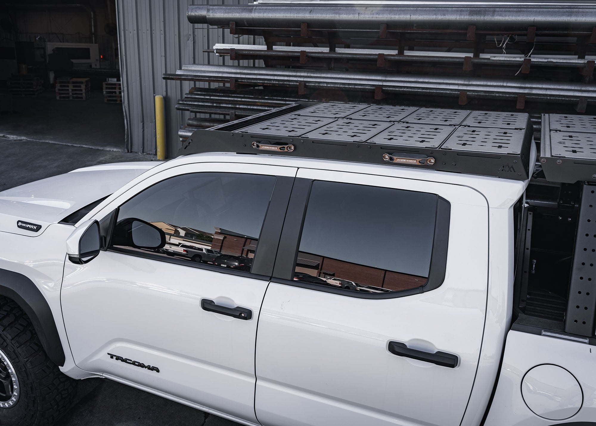 Backwoods Adventure Mods DRIFTR roof rack with accessories installed on a white 2024 4th gen Toyota Tacoma