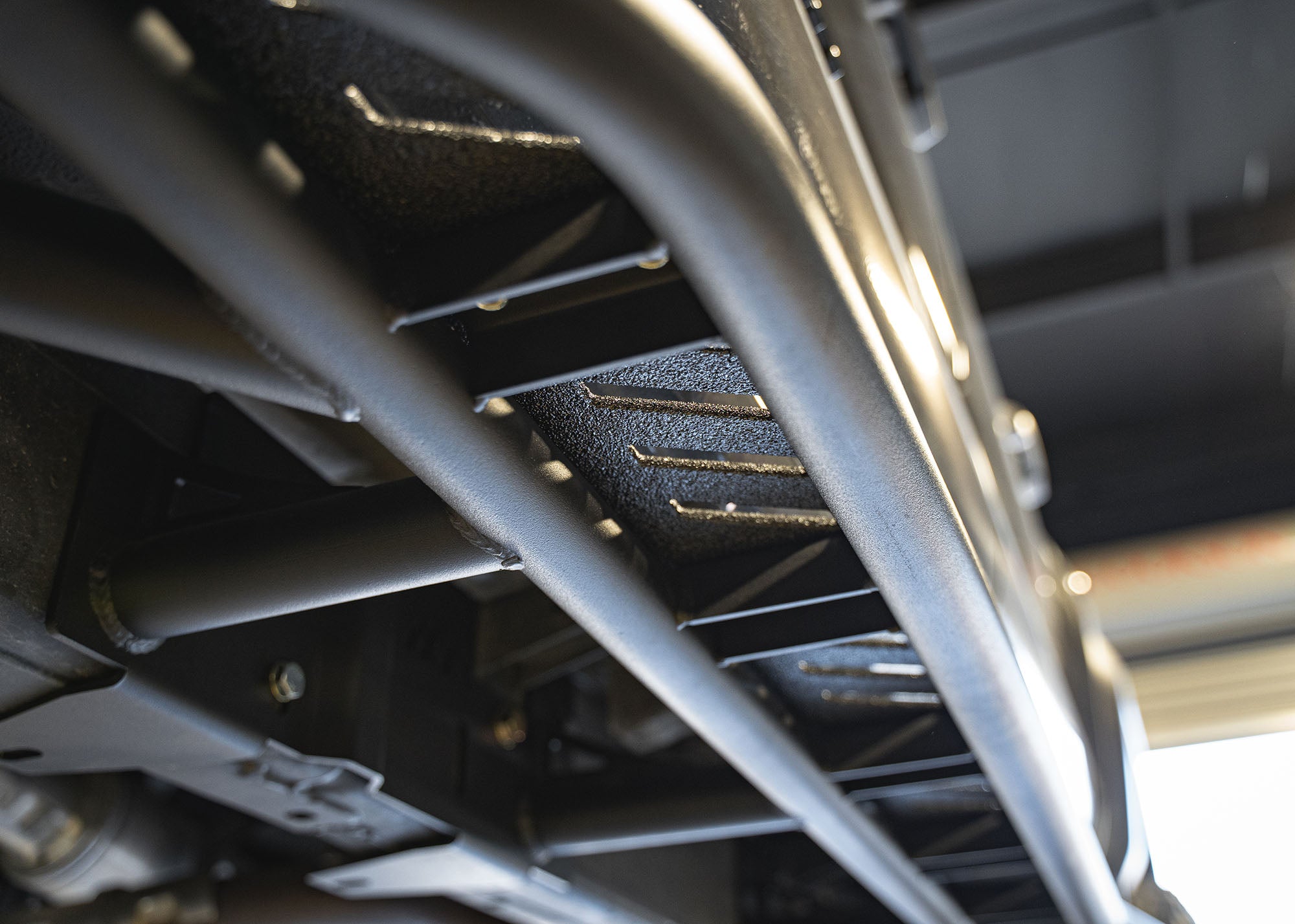 Close up of the underside of the 2024+ Toyota Tacoma Rock Sliders from Backwoods Adventure Mods showing the bolt-on mounting hardware