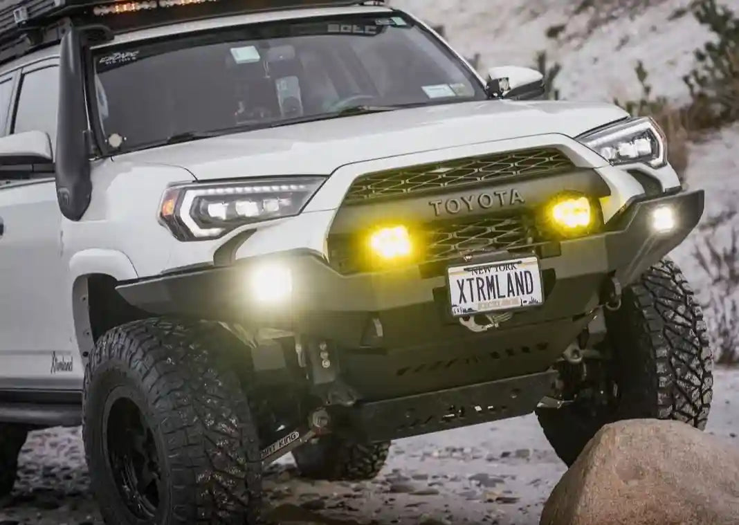Customer with Backwoods Adventure Mods 2014-2022 5th Gen Toyota 4Runner Hi-Lite Overland Front Winch Bumper installed on thier 4runner snow wheeling off road at dusk