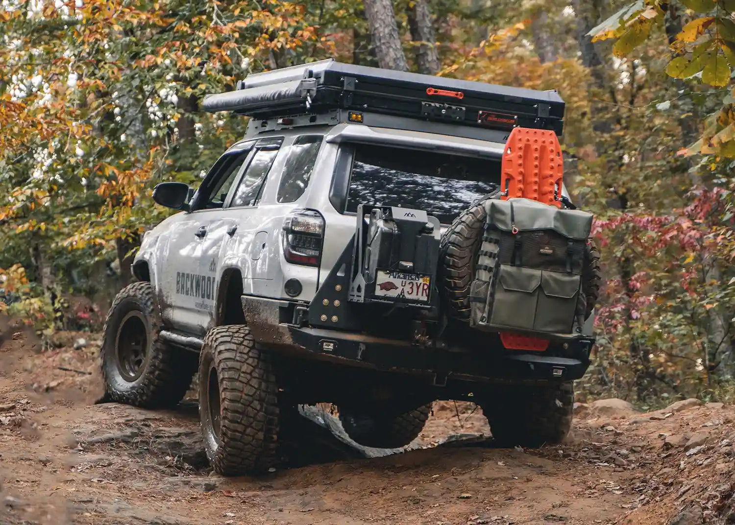 Image of Toyota 4Runner 5th Gen (2010-2024) driving off road with a Backwoods Adventure Mods Hi-Lite High Clearance Dual Swing Out Rear Bumper