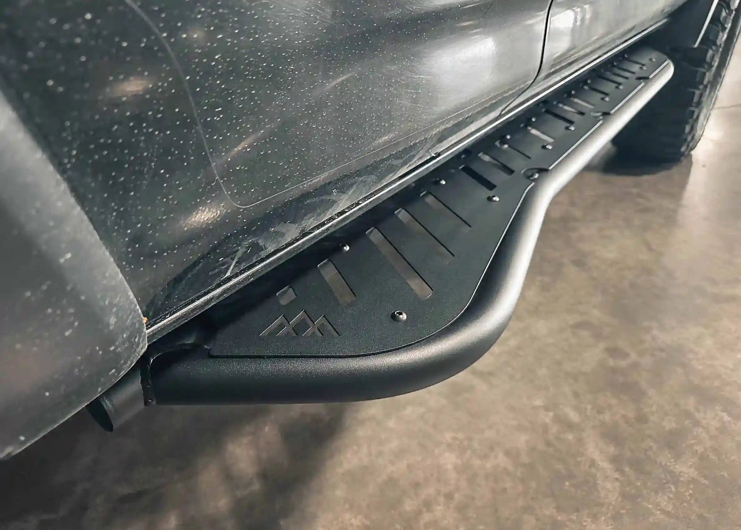 Close up image of the Backwoods Adventure Mods 2010-2024 5th Gen Toyota 4Runner bolt-on Rock Sliders kick-out