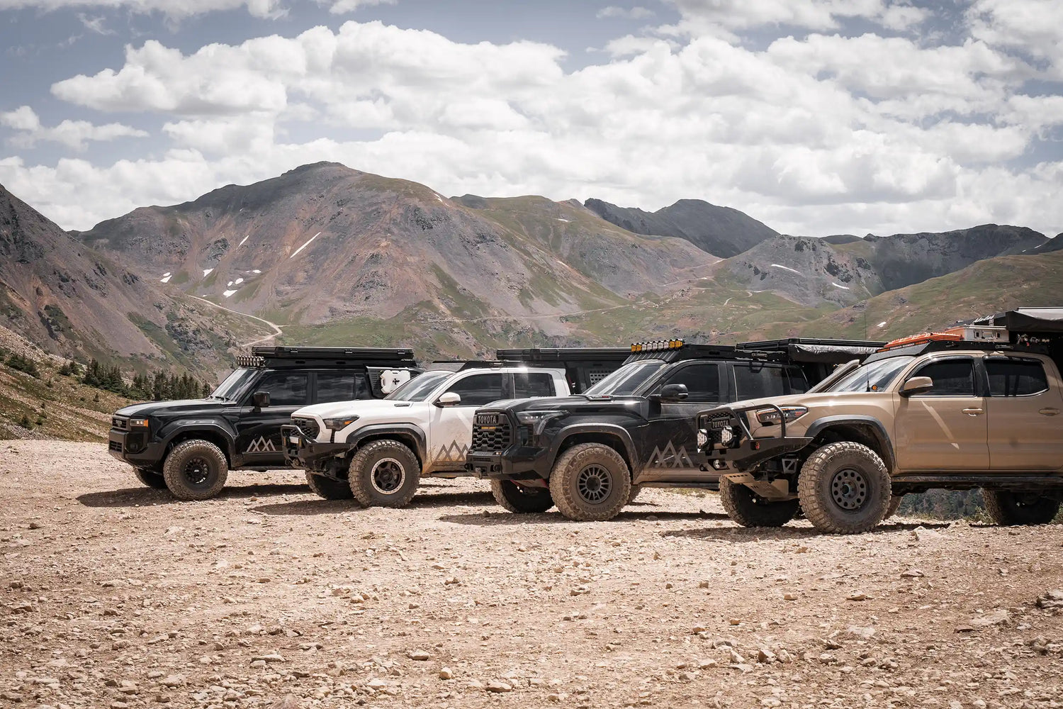 Four Toyota Vehicles fully outfitted with Backwoods Adventure Mods and Accessories parked on a mountain pass in Colorado