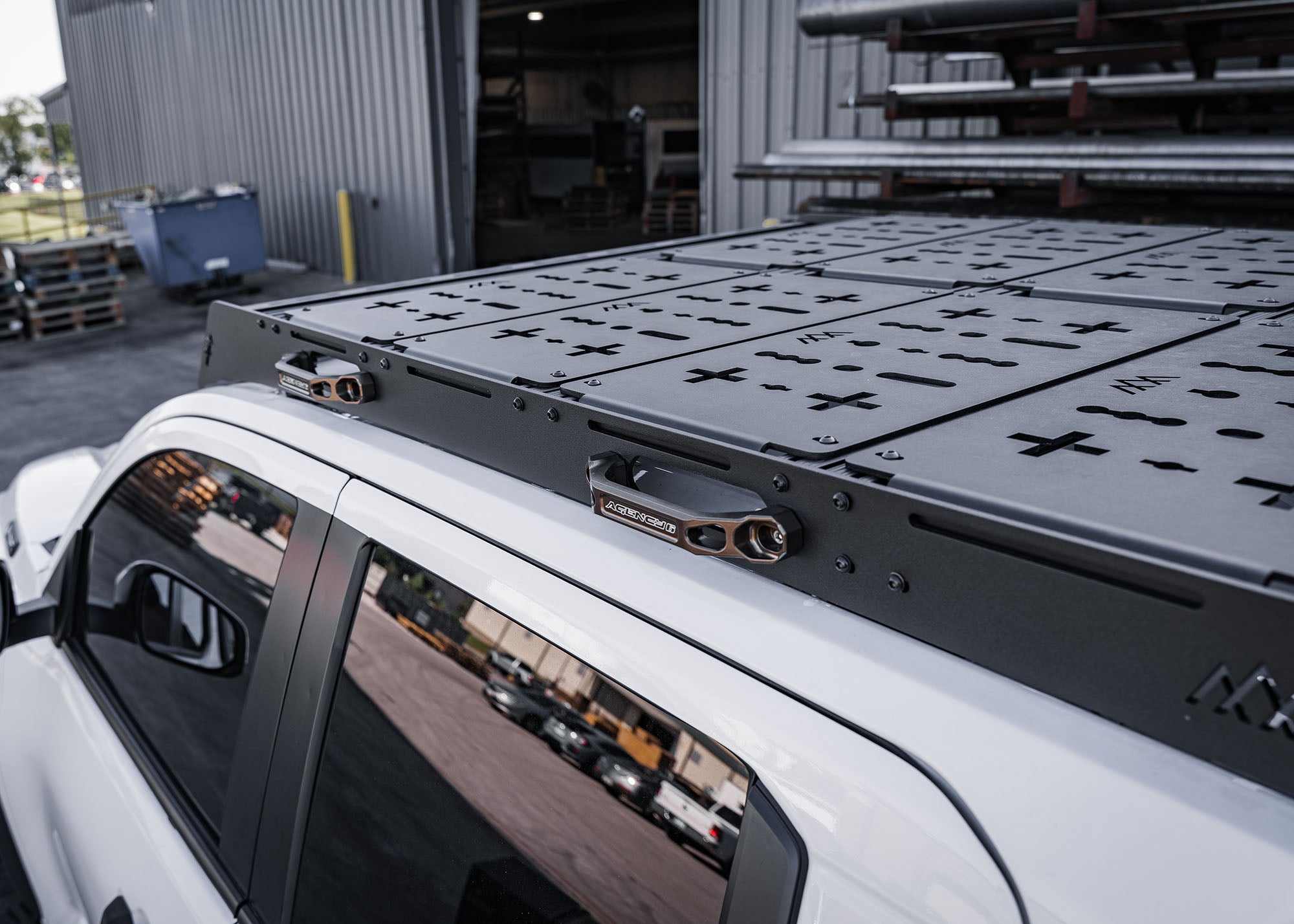 Top view of Backwoods Adventure Mods DRIFTR roof rack on a white 2024 4th gen Toyota Tacoma with deck panel accessories installed