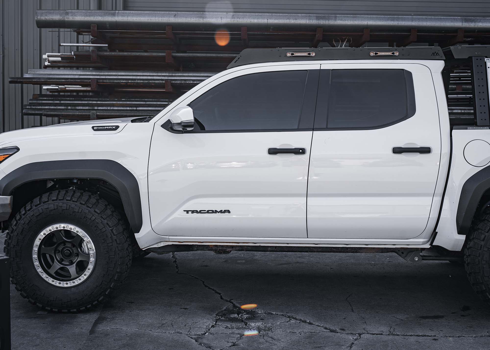 DRIFTR roof rack installed on a white 2024 4th gen Toyota Tacoma with Backwoods Adventure Mods DRIFTR bed rack