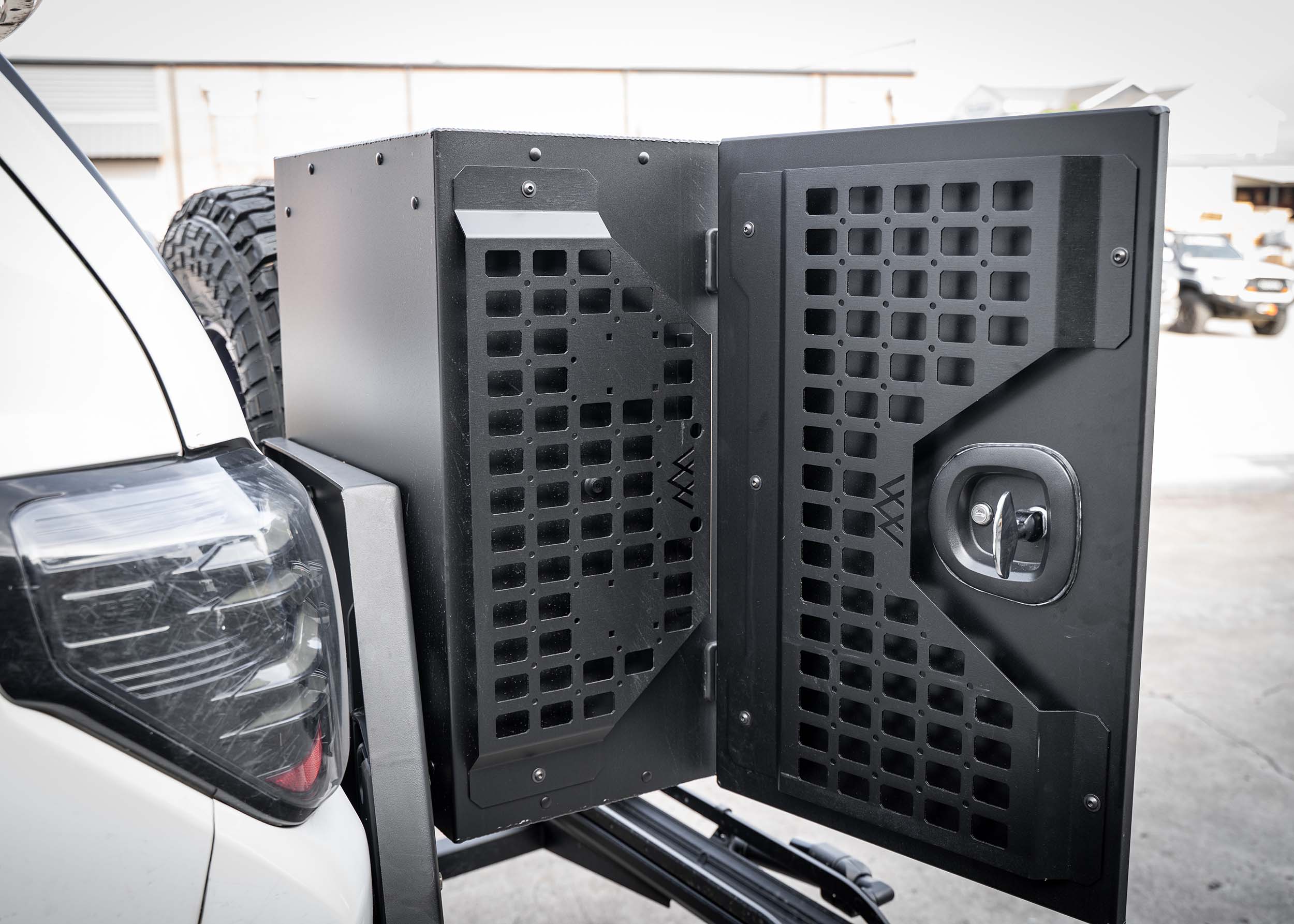 Black vehicle security cage attached to a white car