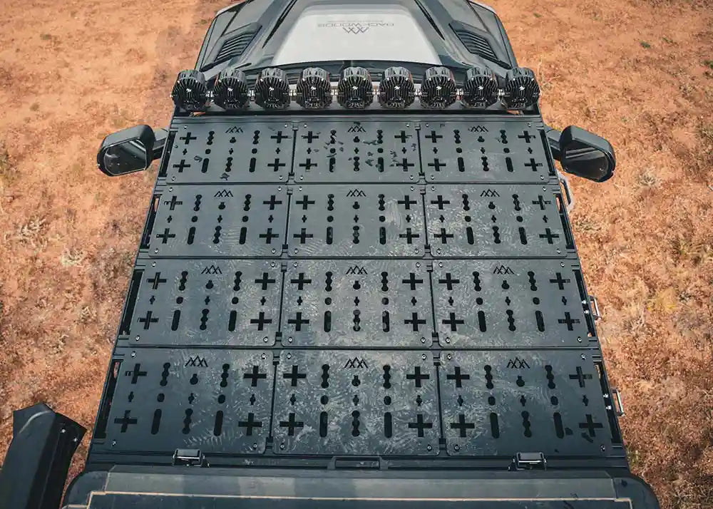 Looking down at the top of the Backwoods Adventure Mods DRIFTR roof rack installed on a 3rd Gen Toyota Tundra with off road lights and deck plate accessories mounted to the roof rack