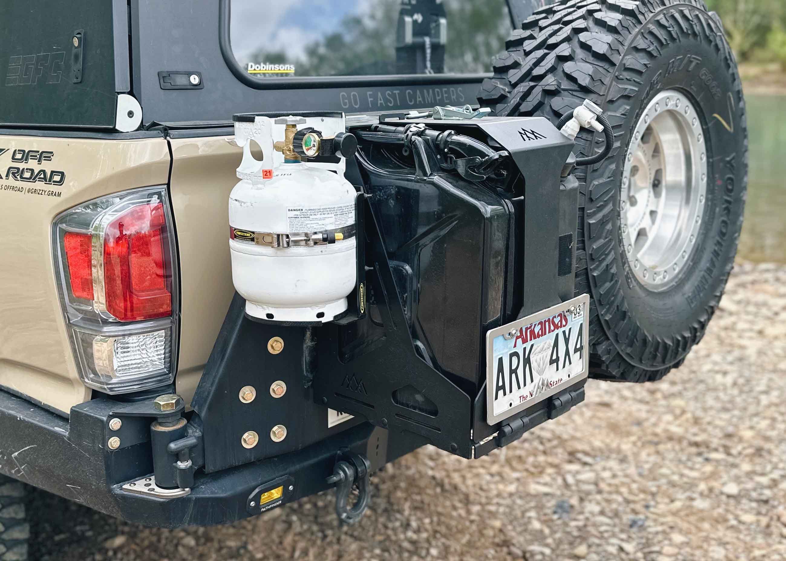 Image a Jerry's Can Holder - Dual Universal Jerry Can Mount from Backwoods Adventure Mods with a propane tank mounted for camping