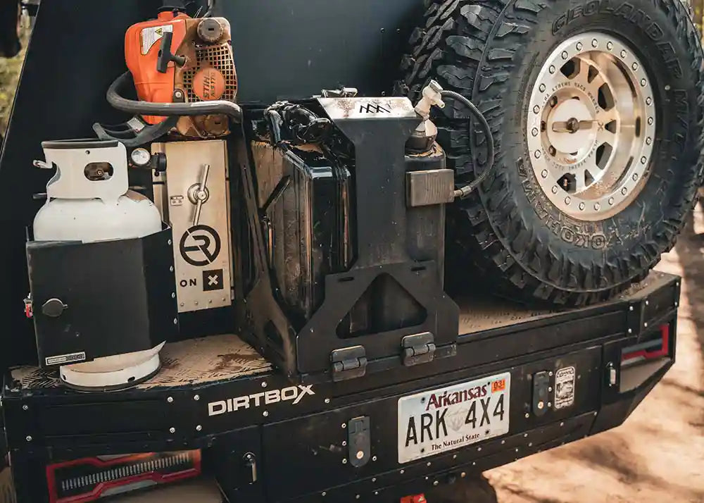 Overland truck with Backwoods Adventure Mods Jerry Can Holder Mount installed for fuel and water storage while camping