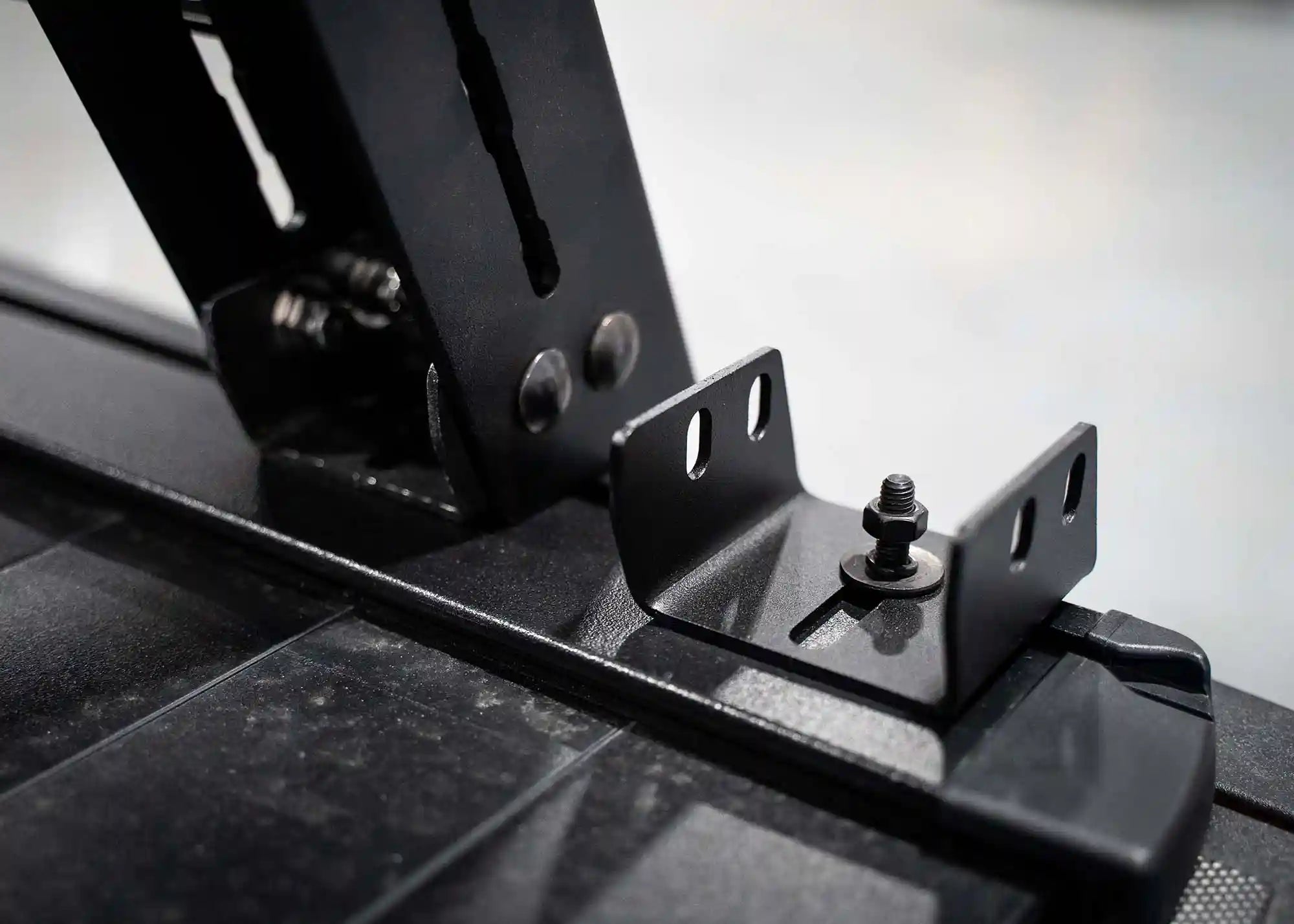 Bed Rack Mounts for Retractable Bed Covers installed to the t-track on a Retrax bed cover | Backwoods Adventure Mods