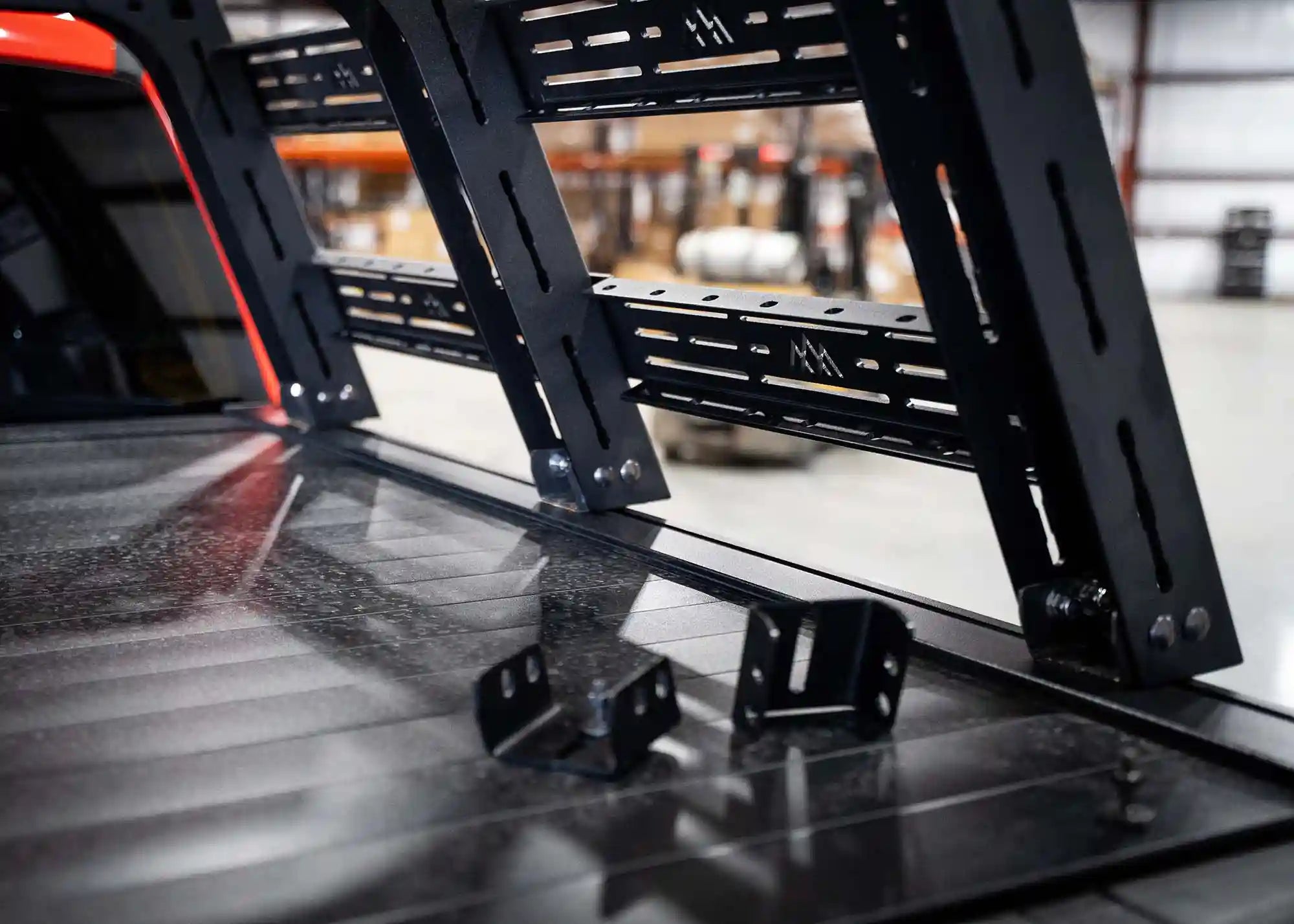 Backwoods Adventure Mods truck bed rack installed on a Retrax bed cover using retractable bed cover mount adapters