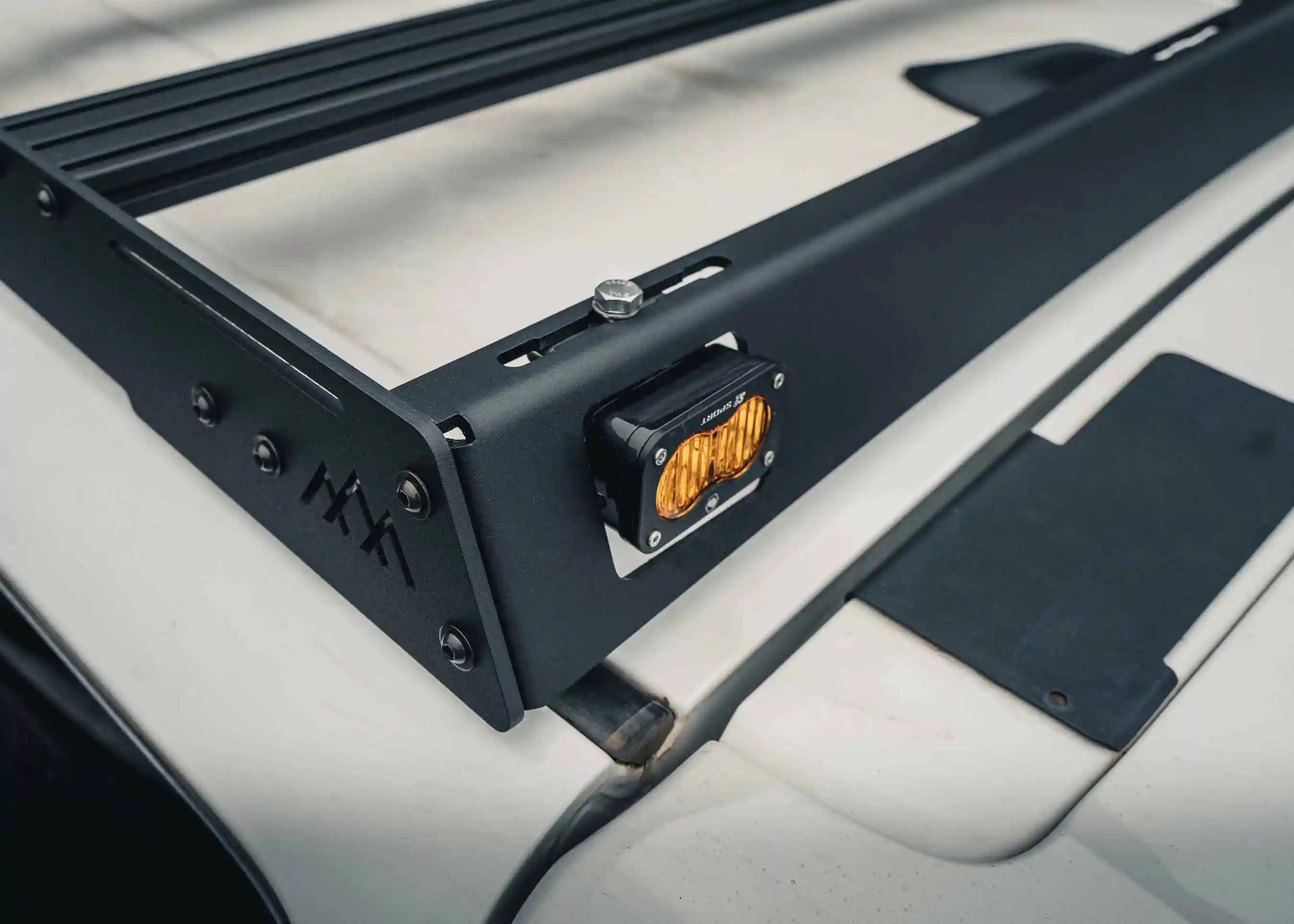 Close up of optional off road light mount in the DRIFTR 6th Gen 4runner roof rack from Backwoods Adventure Mods