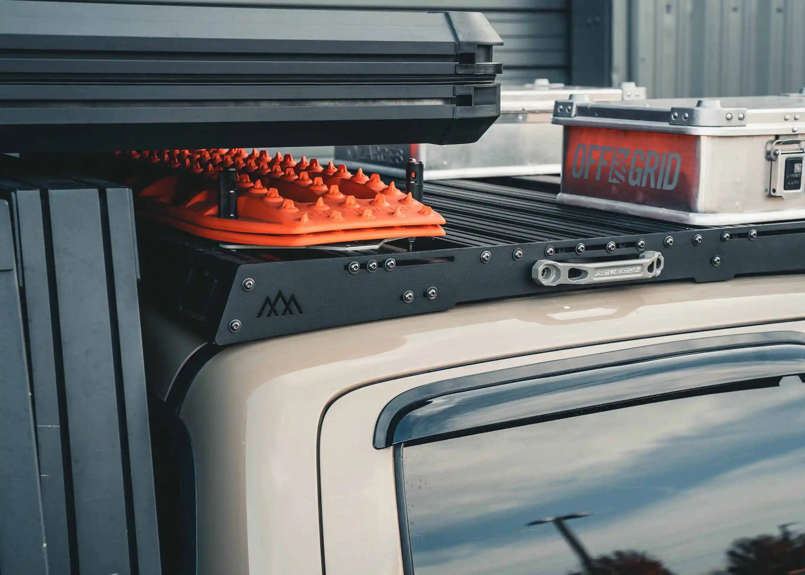 Image showing the back of the Backwoods Adventure Mods 2005-2023 2nd and 3rd Gen Toyota Tacoma DRIFTR Roof Rack with recovery gear and cargo storage boxes mounted