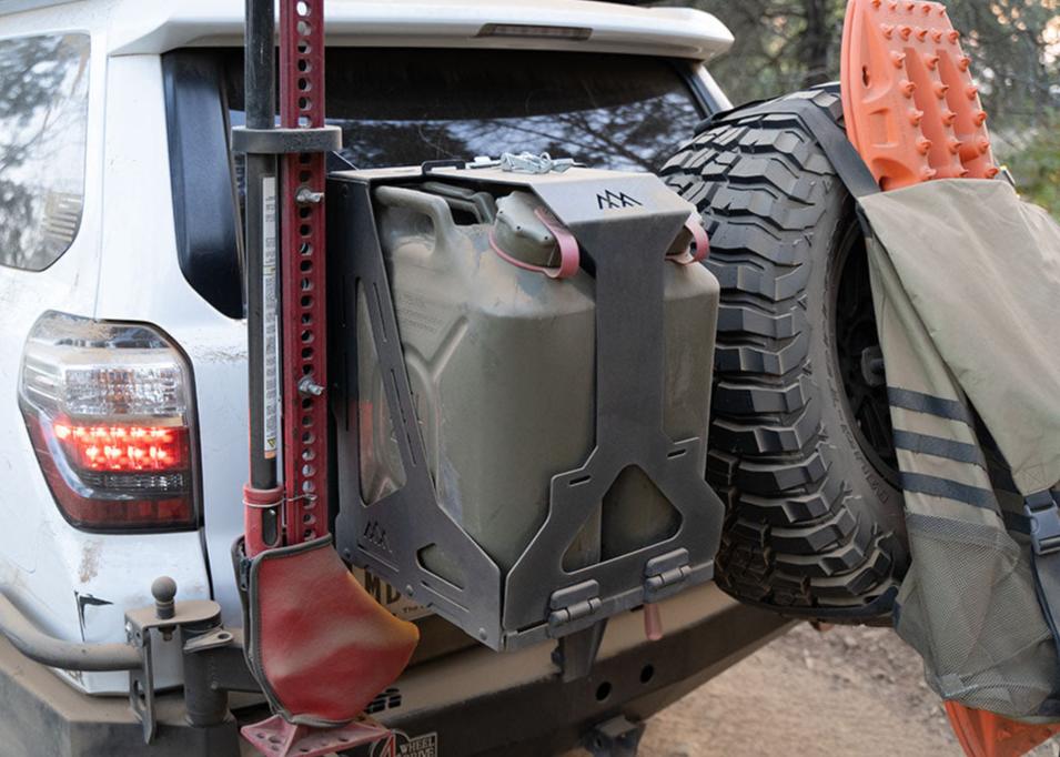 Image of a Jerry's Can Dual jerry Can Holder Mount with off road accessories mounted to the side while overlanding