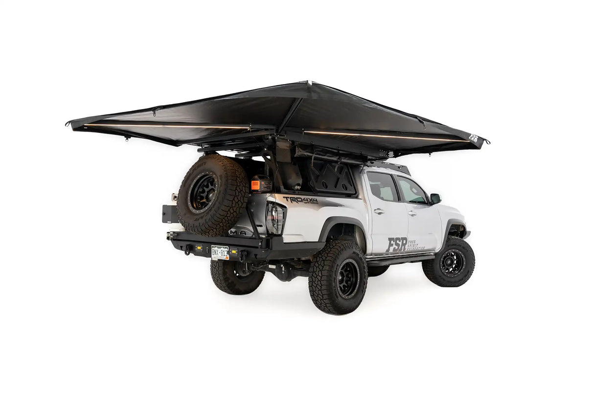 Deployed FSR 270 Awning with integrated lighting illuminated, installed on a 4WD Toyota Tacoma overland truck build