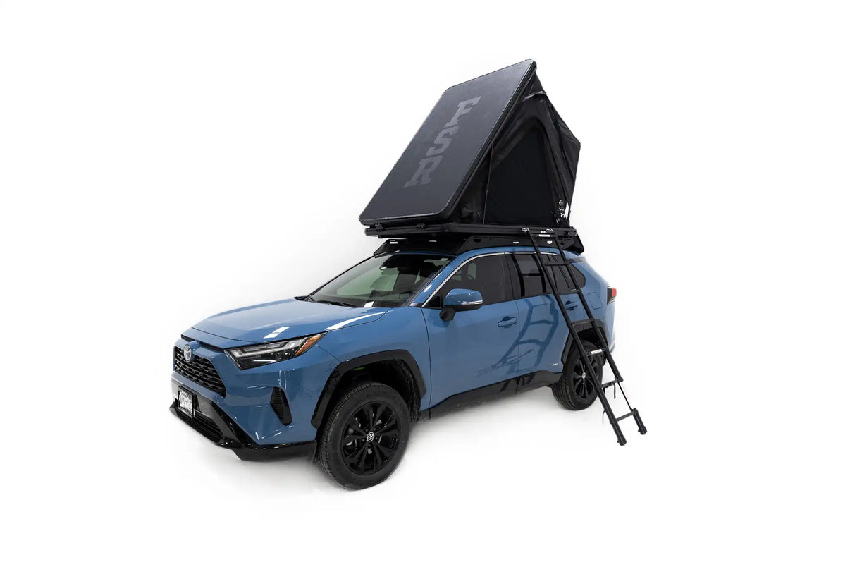 Photo of FSR Aspen Lite Standard Rooftop Tent by Free Spirit Recreation deployed and mounted on a blue Toyota Rav4