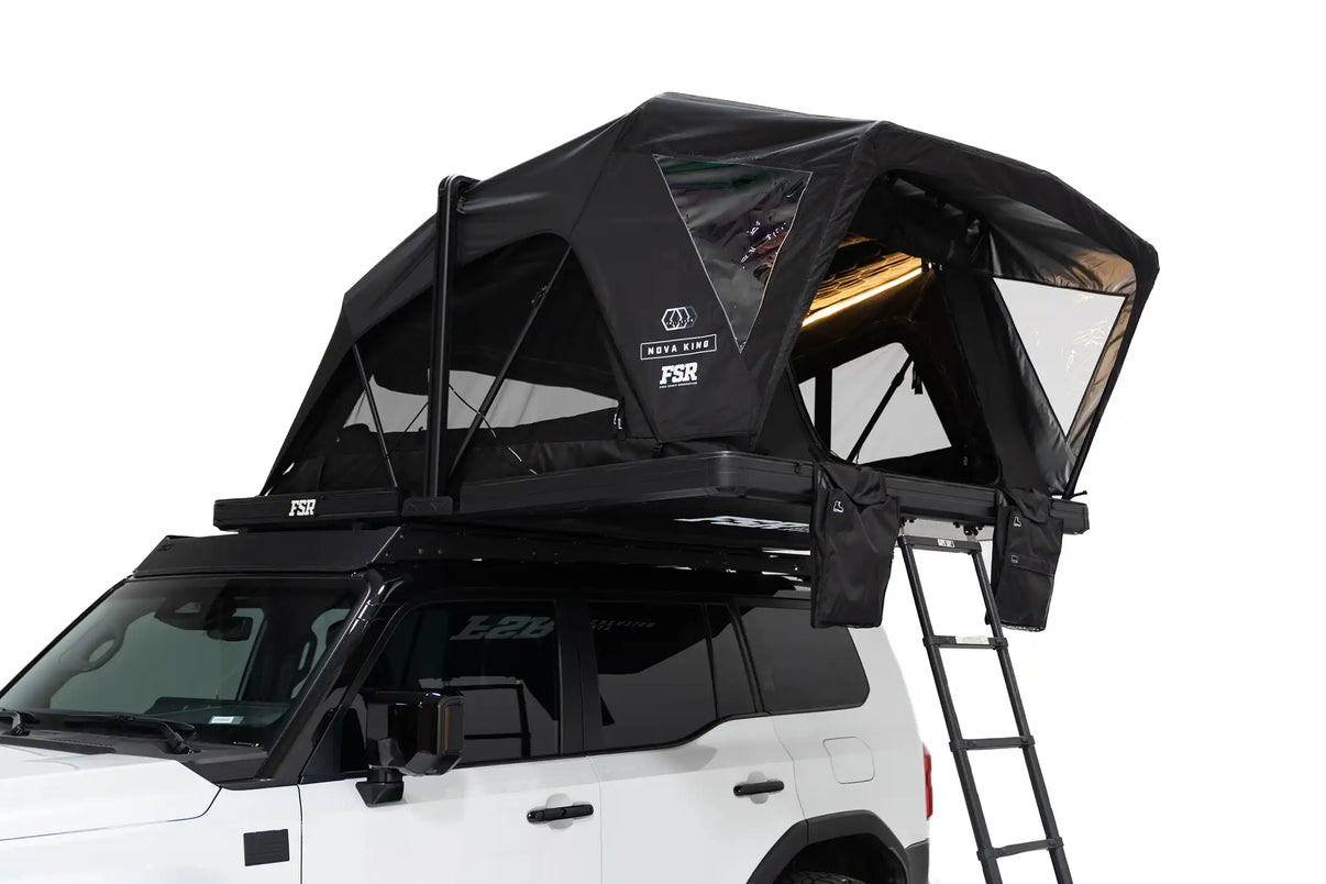 Close-up exterior photo of the FSR Nova King rooftop tent mounted with the interior LED tent lights on. | Backwoods Adventure Mods