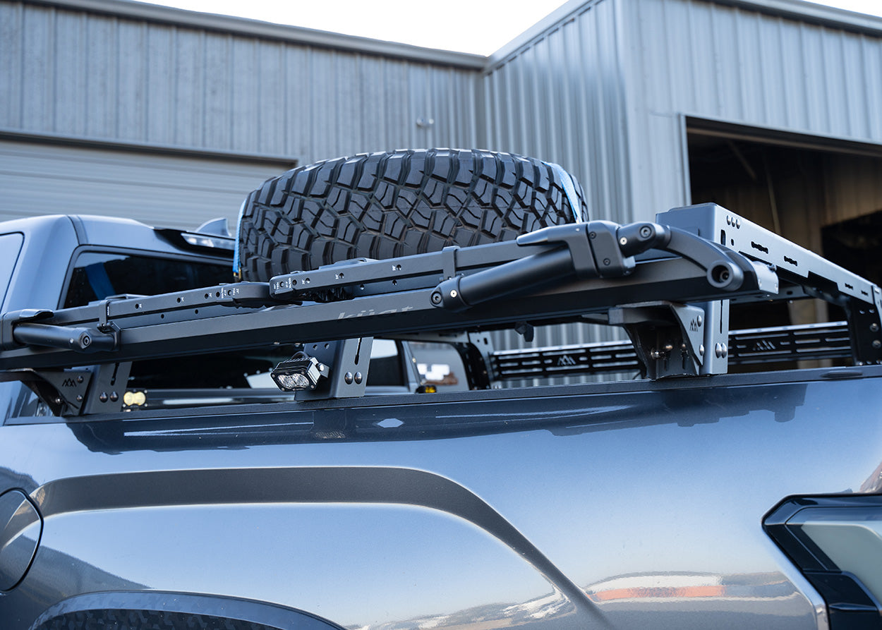 Backwoods Adventure Mods Universal Truck Bed Rack Bike Tray Mounting Brackets installed on a Toyota tacoma bed rack