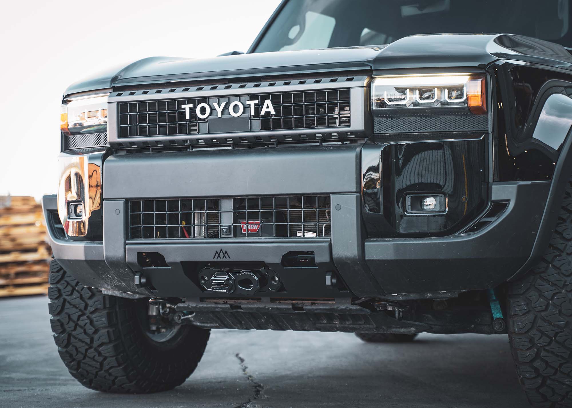 Backwoods Adventure Mods Land Cruiser 250 Front Bumper with winch installed on a Black 2024 LC250