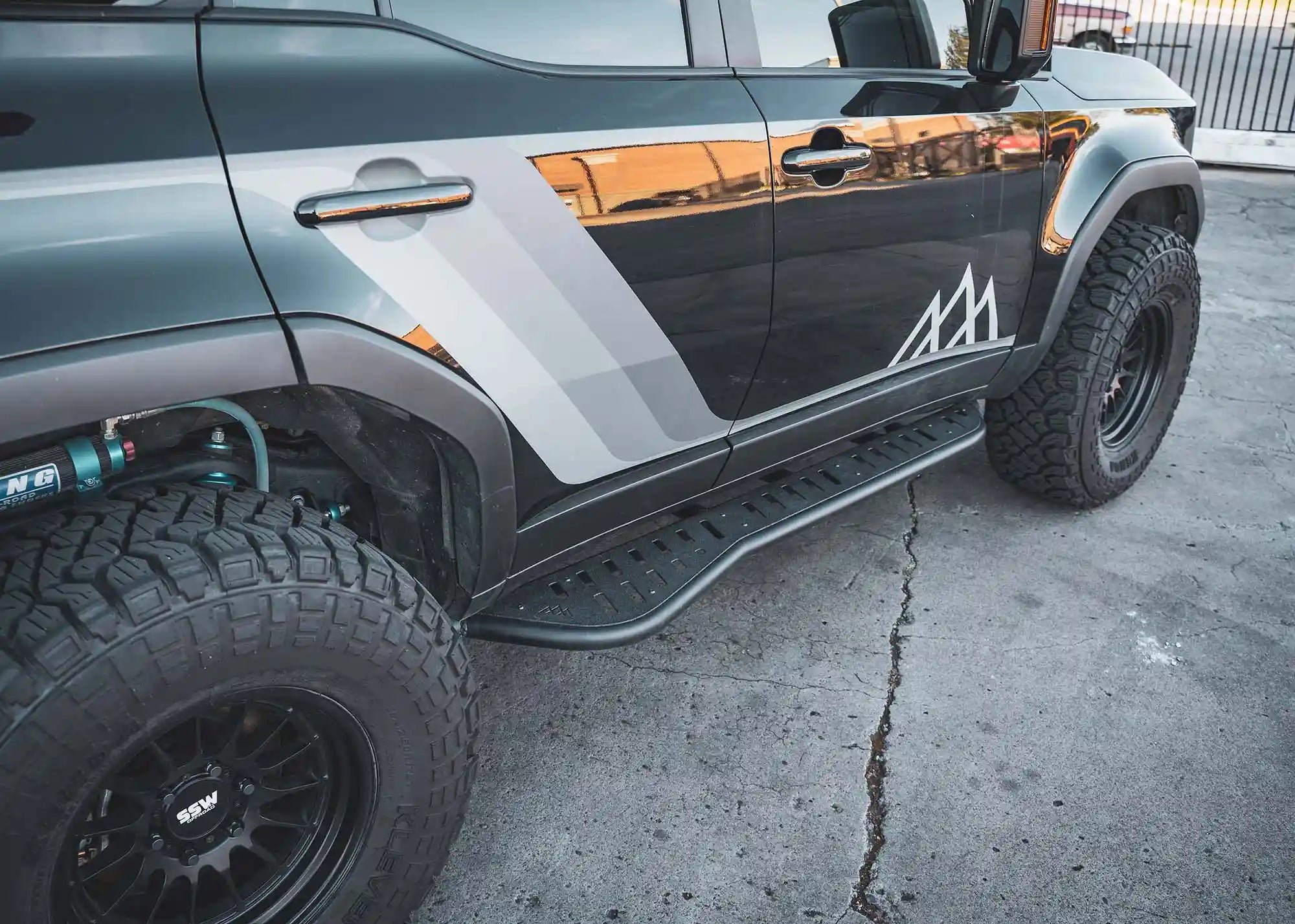 Black Land Cruiser 250 with LC250 rock sliders installed from Backwoods Adventure Mods