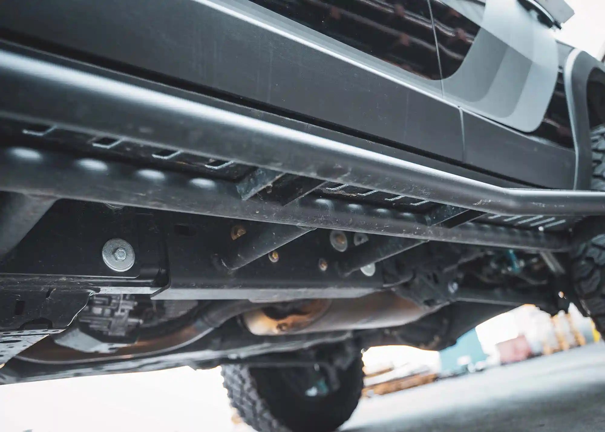 Close up of the bolt-on mount for the Land Cruiser 250 LC250 Rock Sliders from Backwoods Adventure Mods