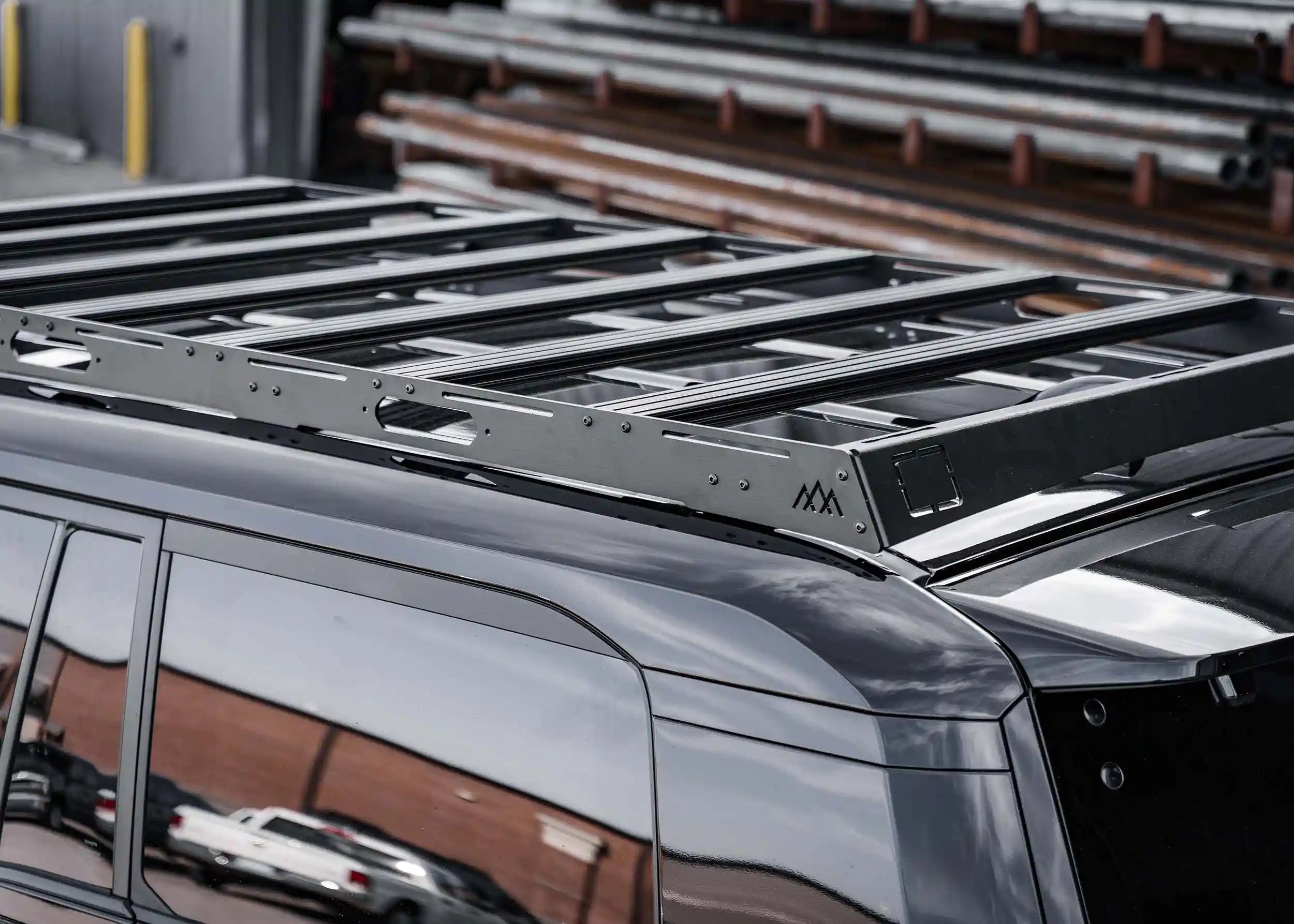 T-track accessory load bars included with the Backwoods Adventure Mods DRIFTR LC250 roof rack for Toyota Land Cruiser 250