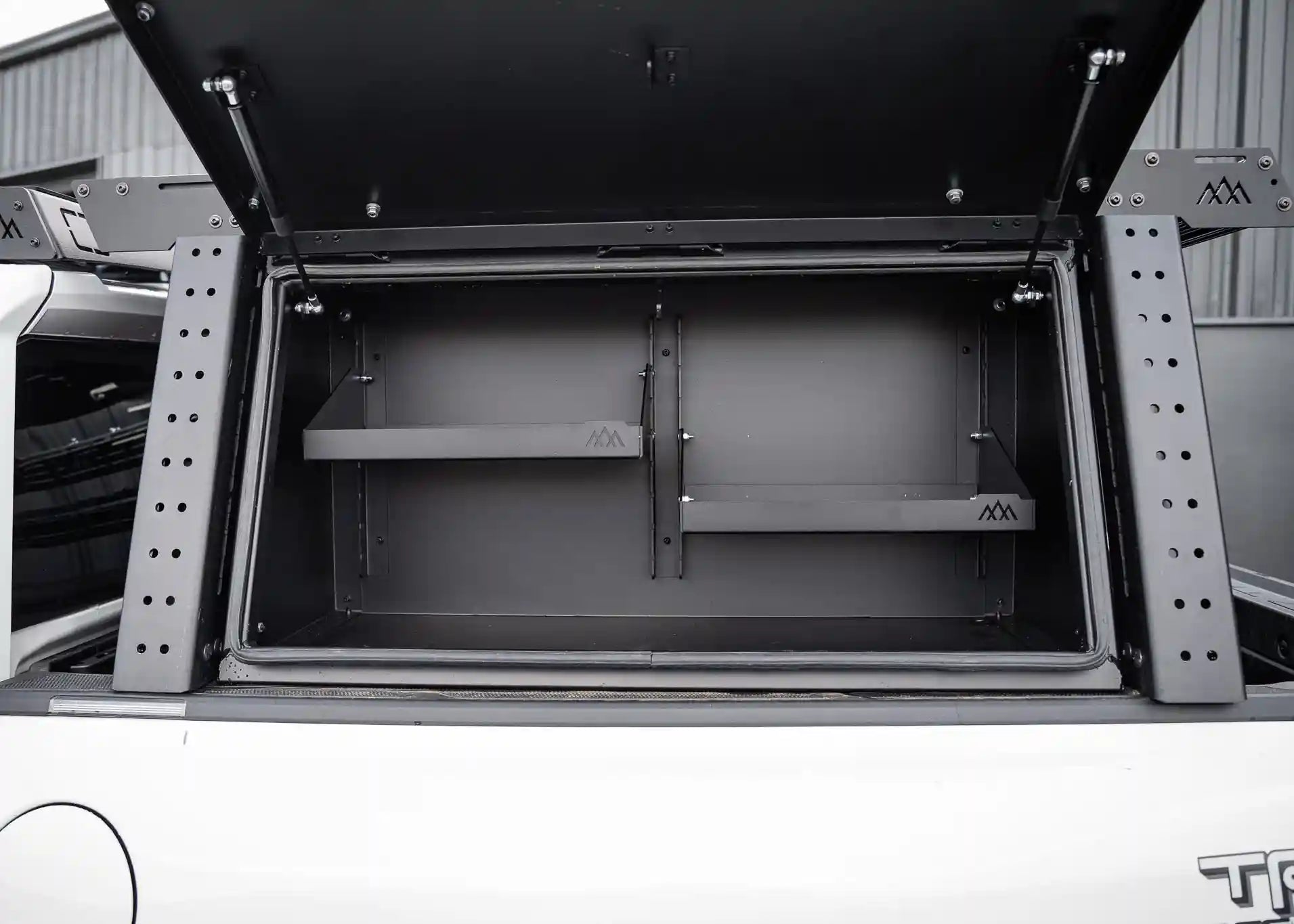 Backwoods Adventure Mods Truck Bed Rack System Overland Enthusiast Bundle installed on a Toyota Tacoma with rack mounted cargo box open