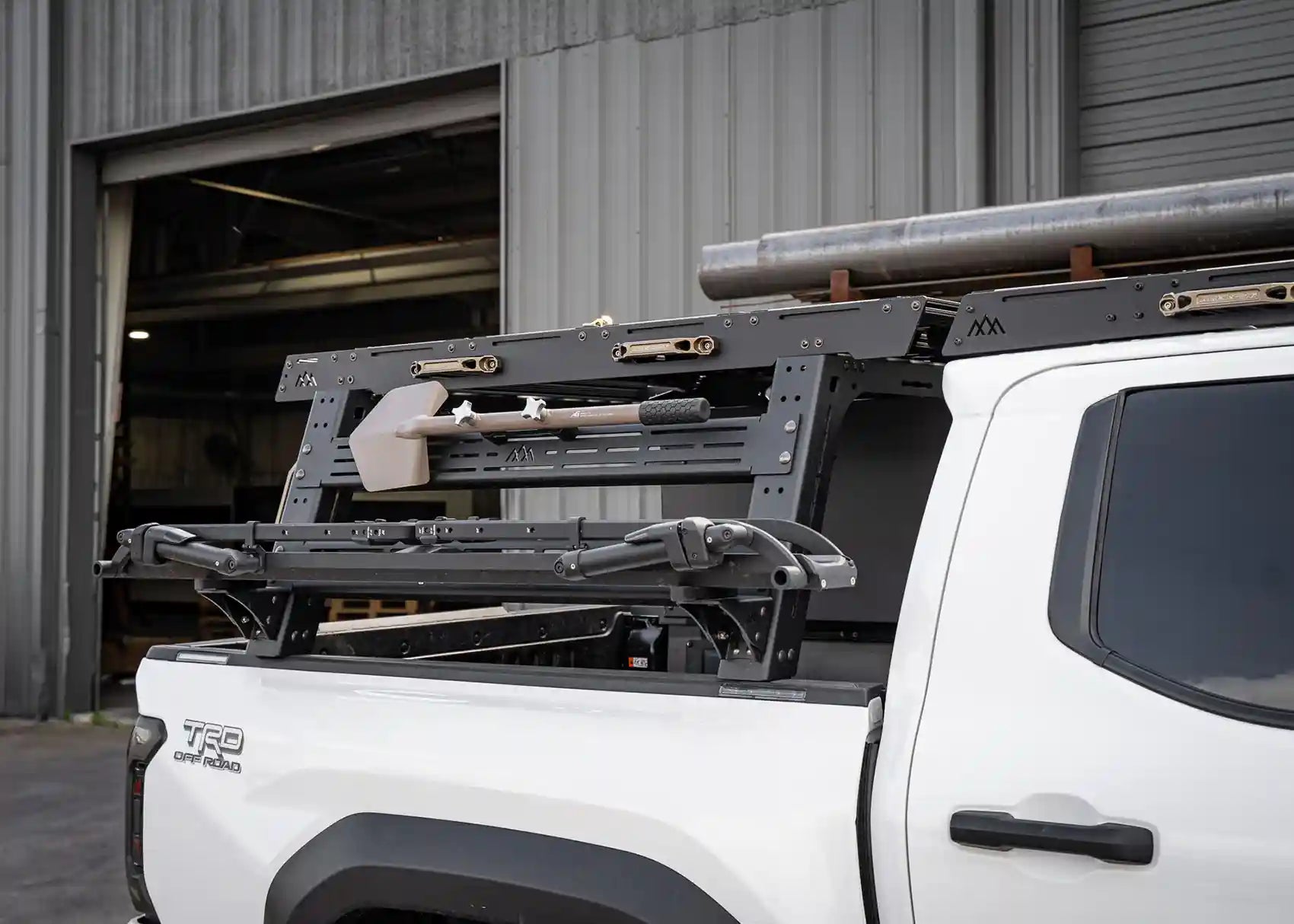 Backwoods Adventure Mods Truck Bed Rack System Starter Bundle installed on a Toyota Tacoma with rack mounted off road accessories and bike rack