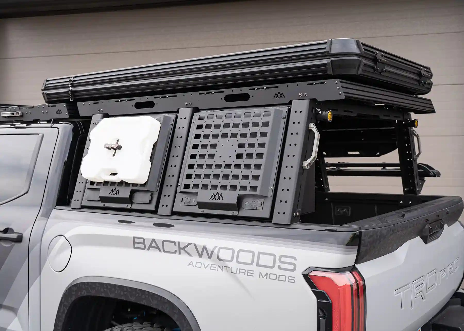 Backwoods Adventure Mods Toyota Tundra Aluminum Truck Bed Rack Storage Box closed with accessories mounted to the included molle panels