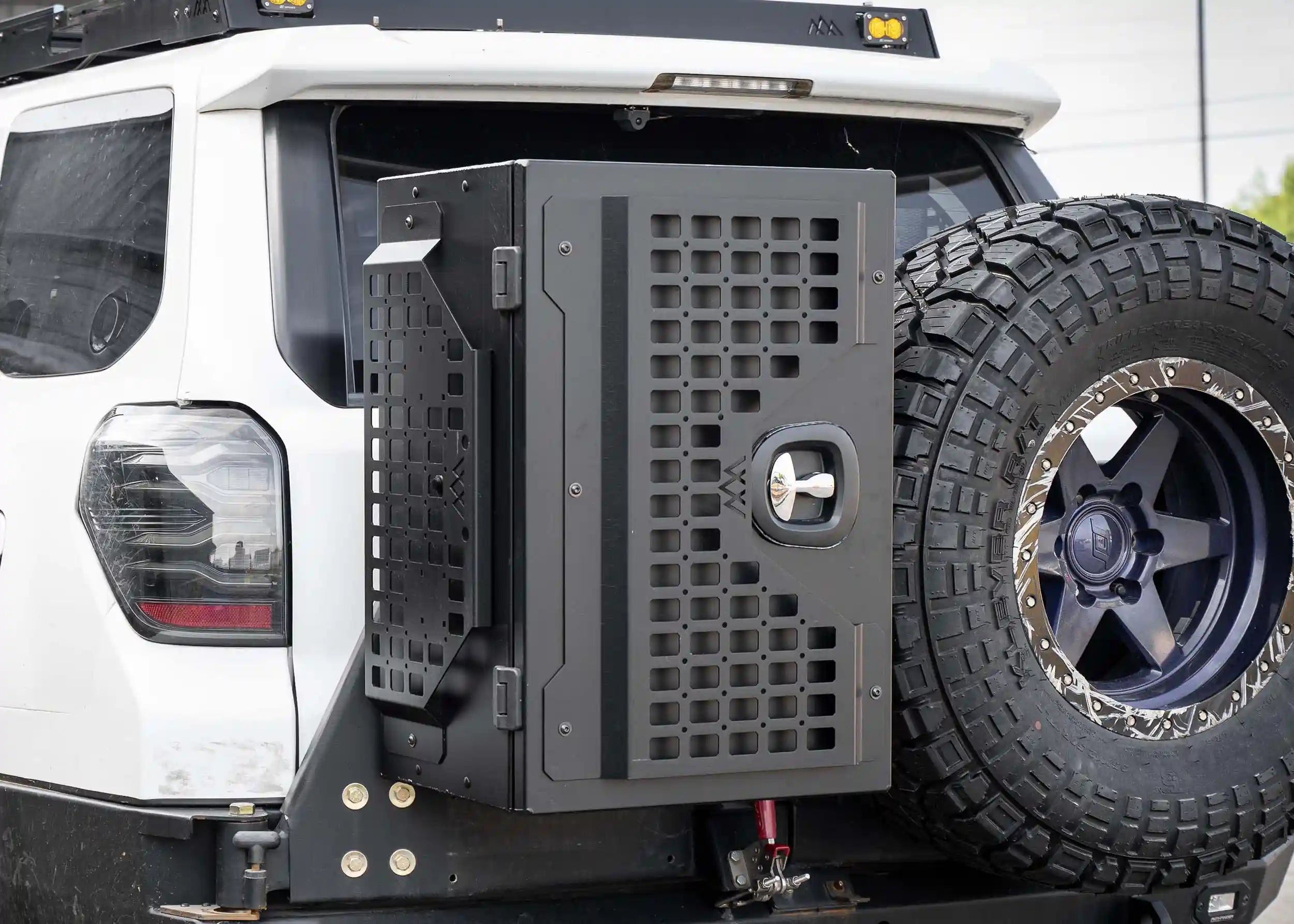 Backwoods Adventure Mods Universal off-road overland vehicle gear storage cargo box attached to a white 4runner swingout bumper