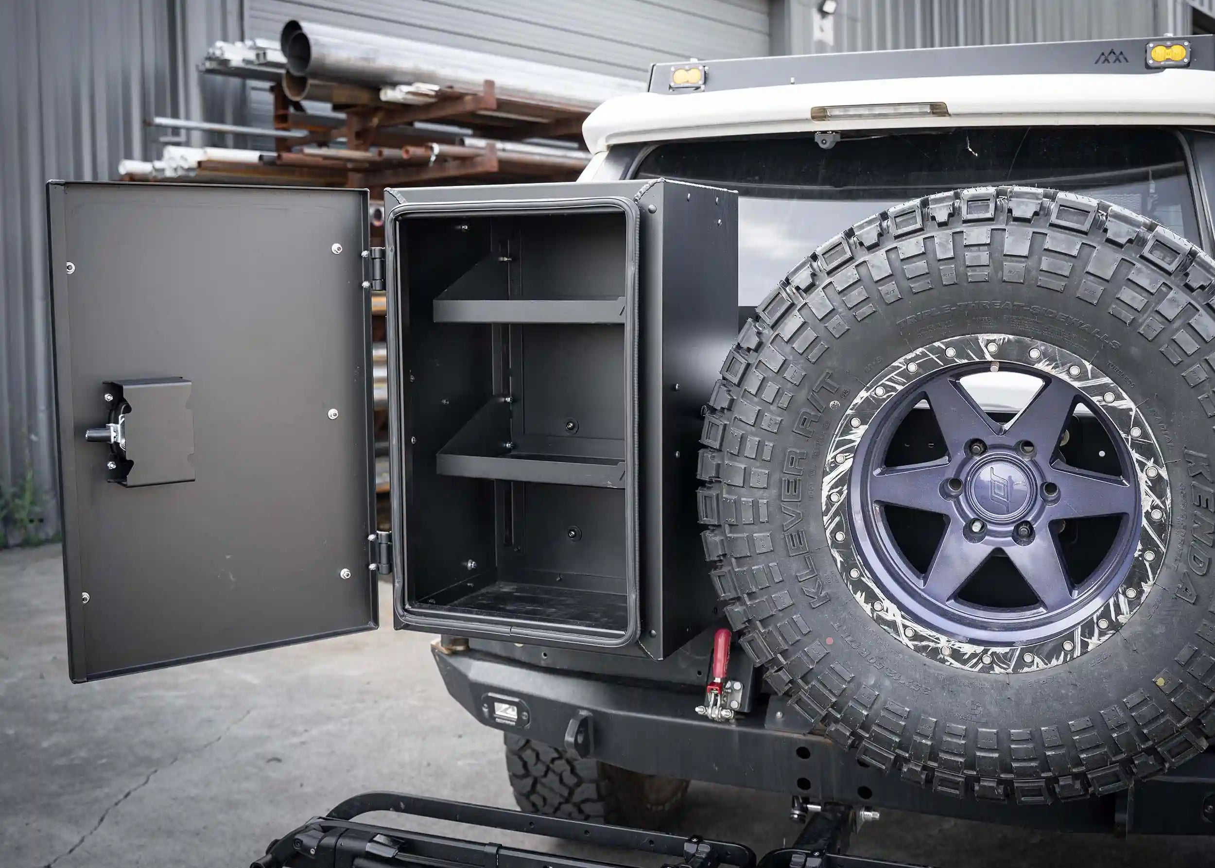 Interior of the Backwoods Adventure Mods Universal off-road vehicle overland gear storage cargo box installed on a white Toyota 4Runner