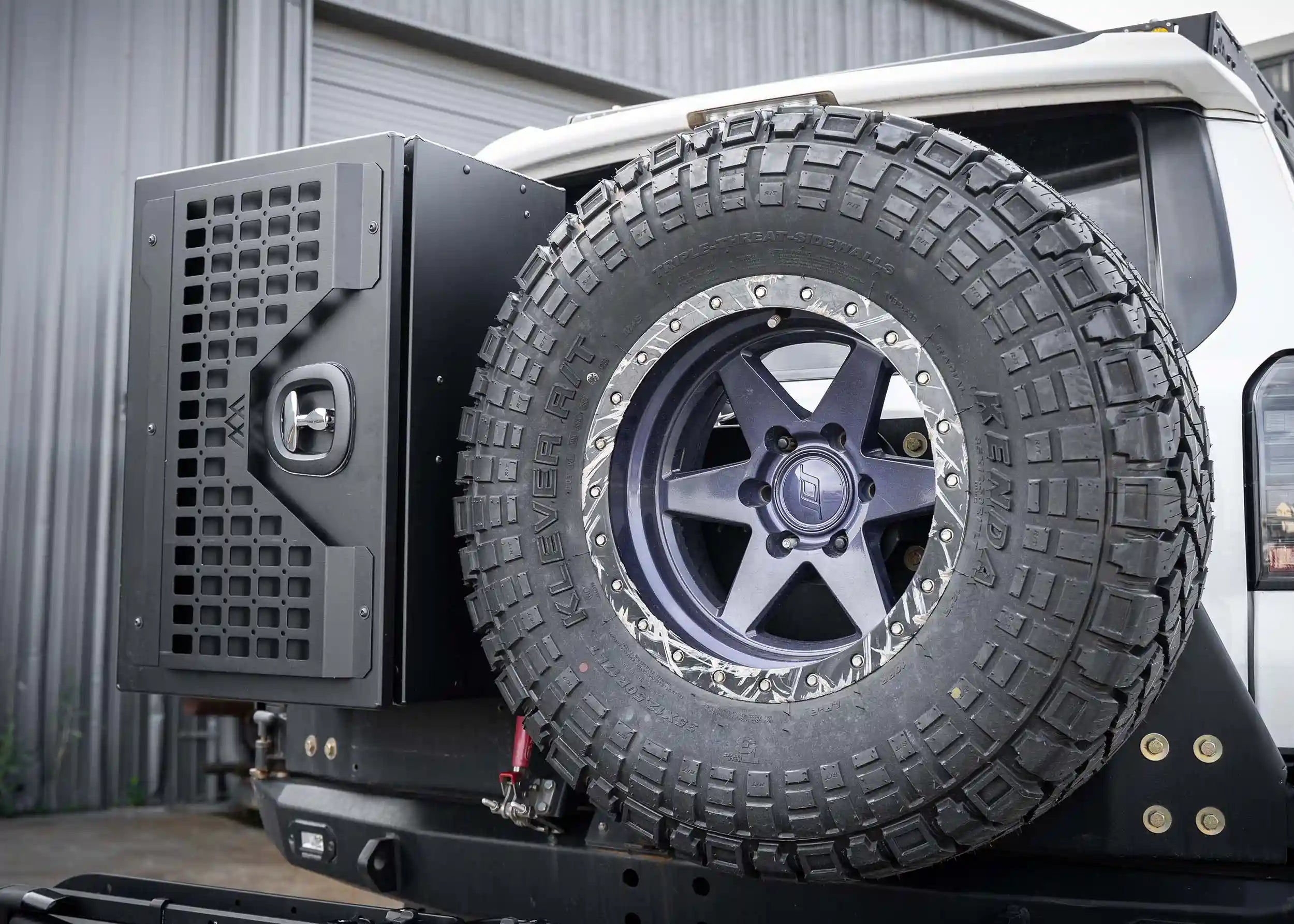 Side profile of the Backwoods Adventure Mods Universal overland gear storage cargo box mounted on an off-road vehicle swing out bumper