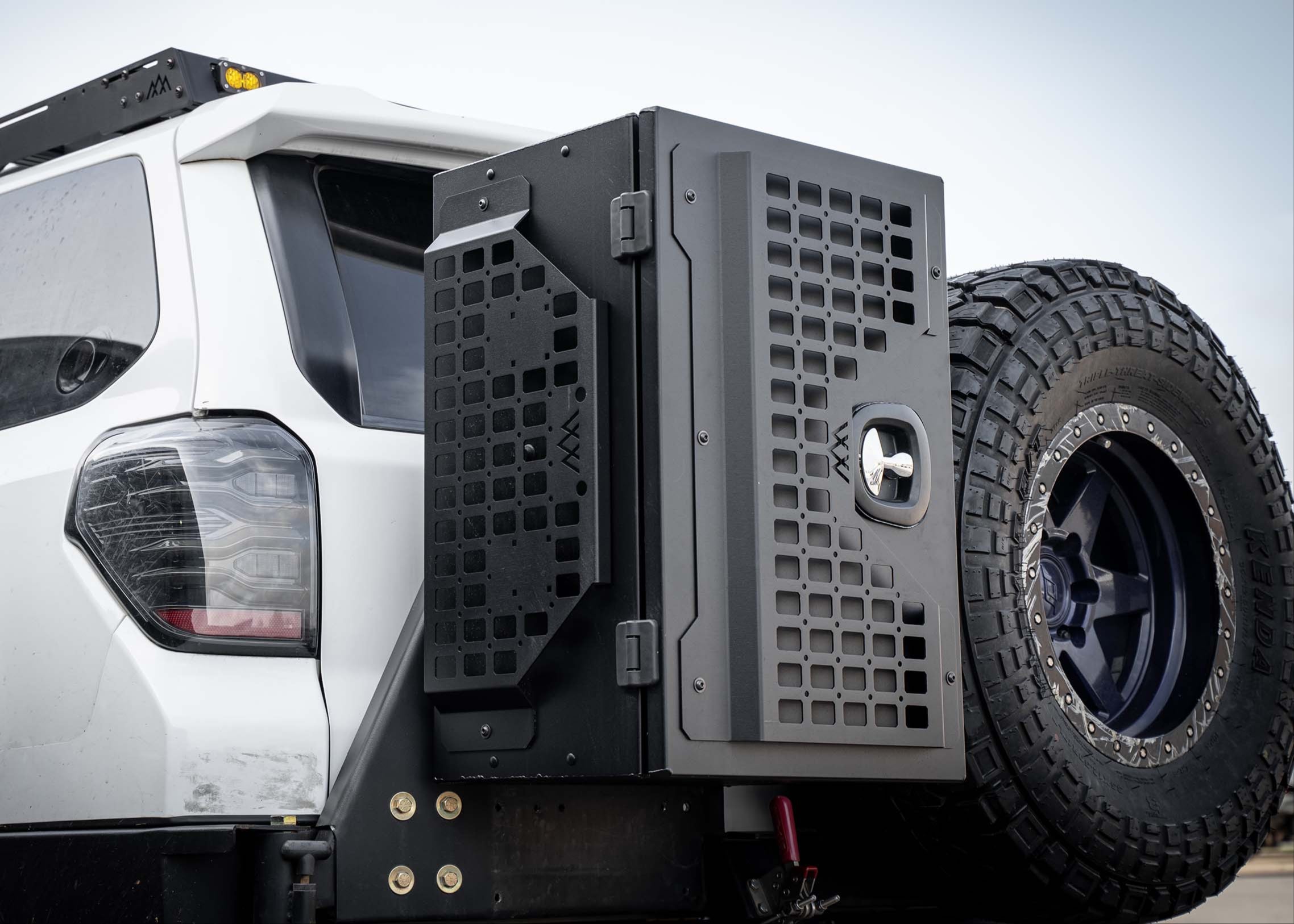 Backwoods Adventure Mods Universal off-road vehicle overland gear storage cargo box attached to a white truck
