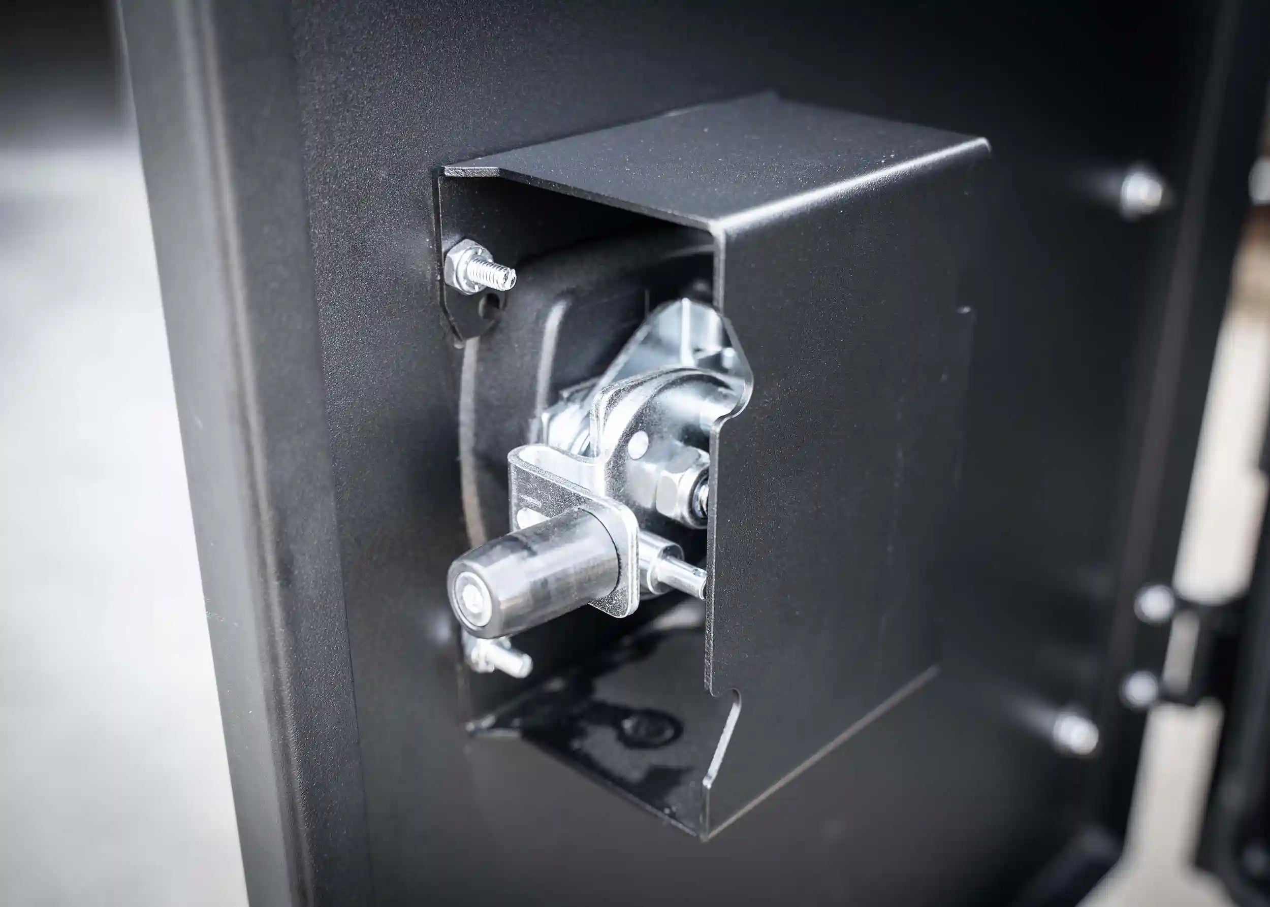 Heavy-duty lock mechanism on the Backwoods Adventure Mods Universal off-road vehicle overland gear storage cargo box attached to a white truck