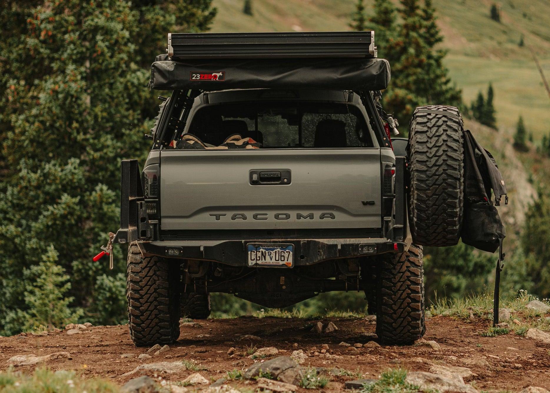 Backwoods Adventure Mods 2016-2023 3rd Gen Toyota Tacoma Hi-Lite High Clearance Dual Swing Out Rear Bumper with swingouts open and spare tire mounted