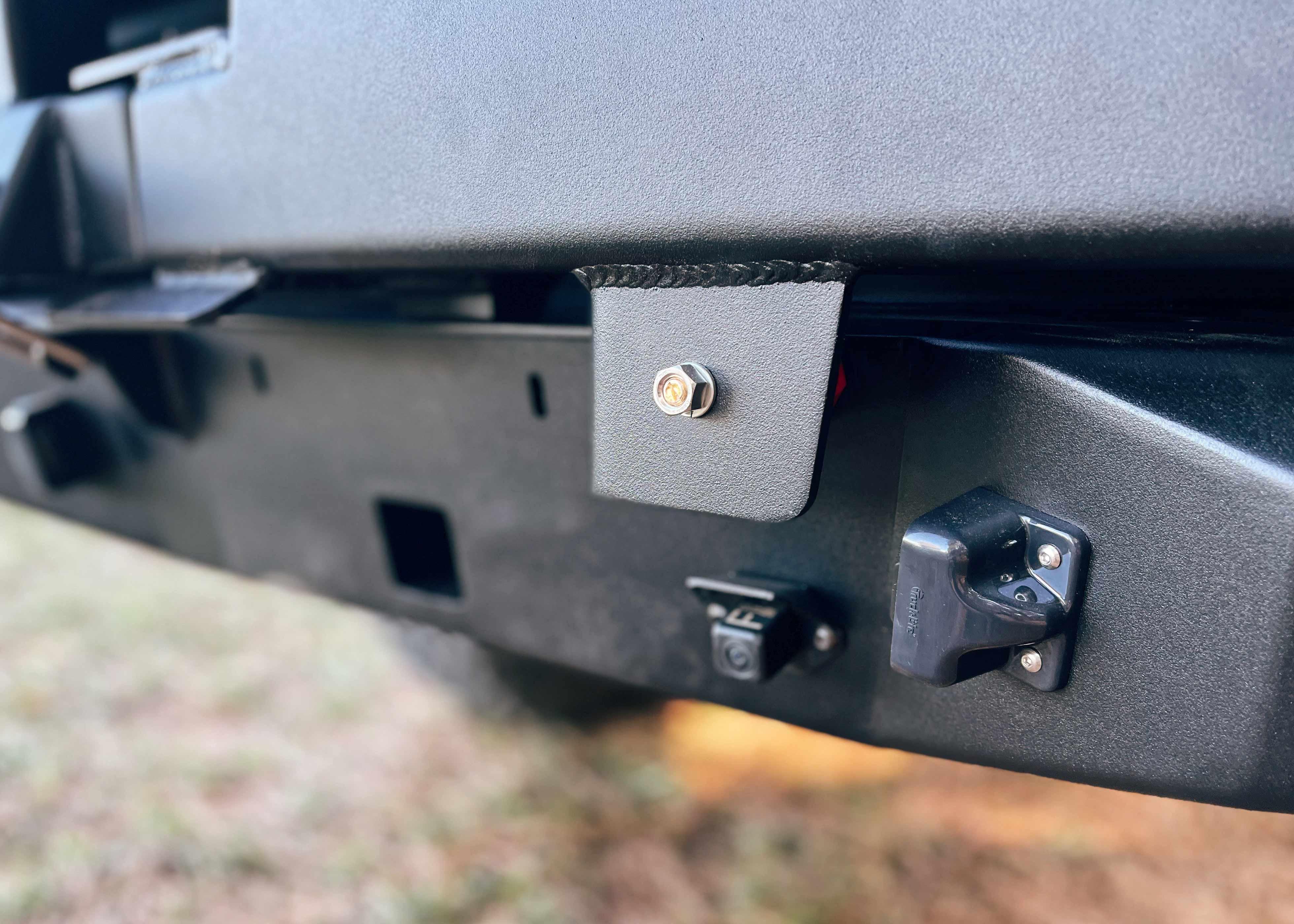 Close up of the close dampener on the Backwoods Adventure Mods 2016-2023 3rd Gen Toyota Tacoma Hi-Lite High Clearance Dual Swing Out Rear Bumper 
