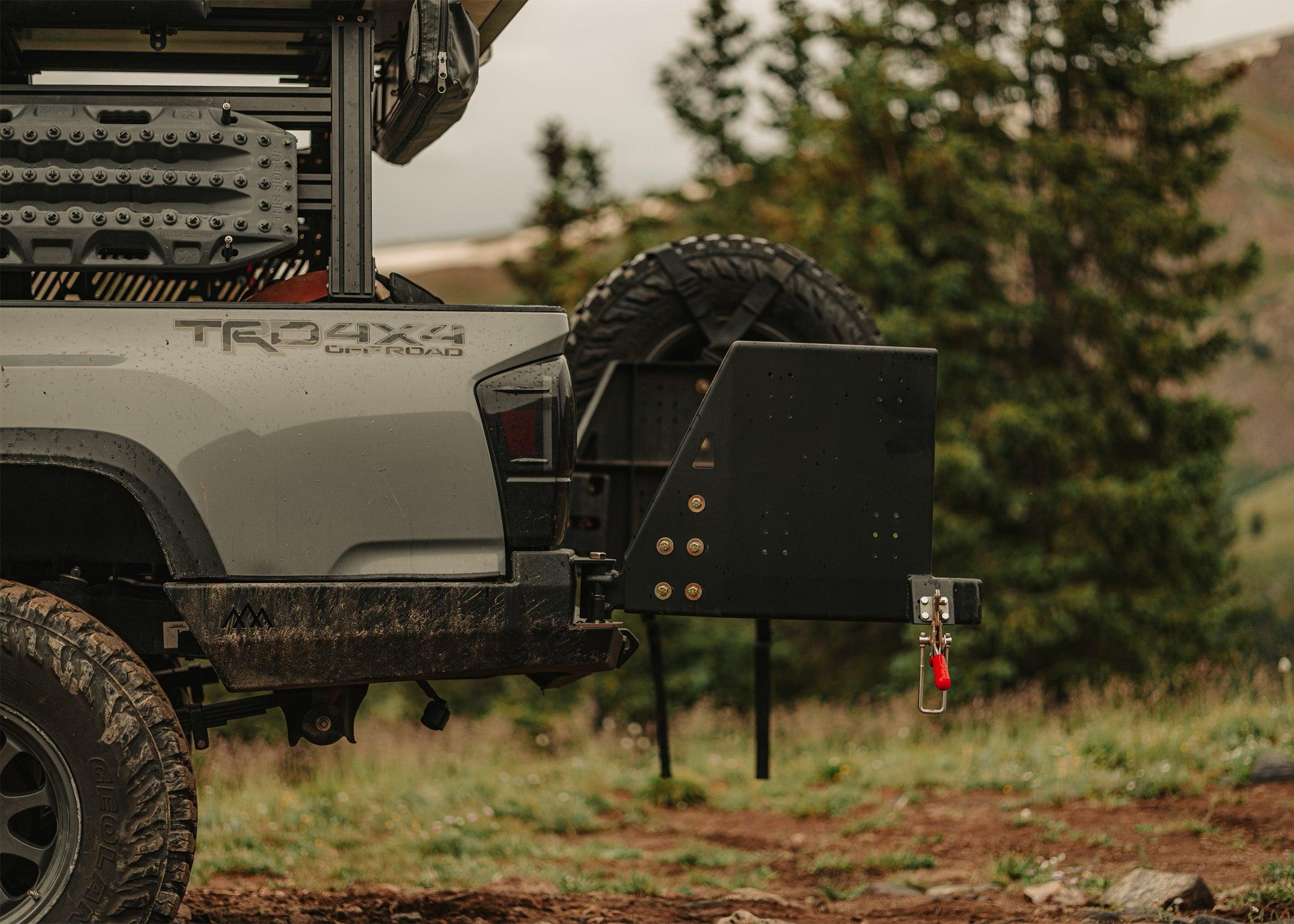 Side-facing image of the Backwoods Adventure Mods 2016-2023 3rd Gen Toyota Tacoma Hi-Lite High Clearance Dual Swing Out Rear Bumper with both swing outs open