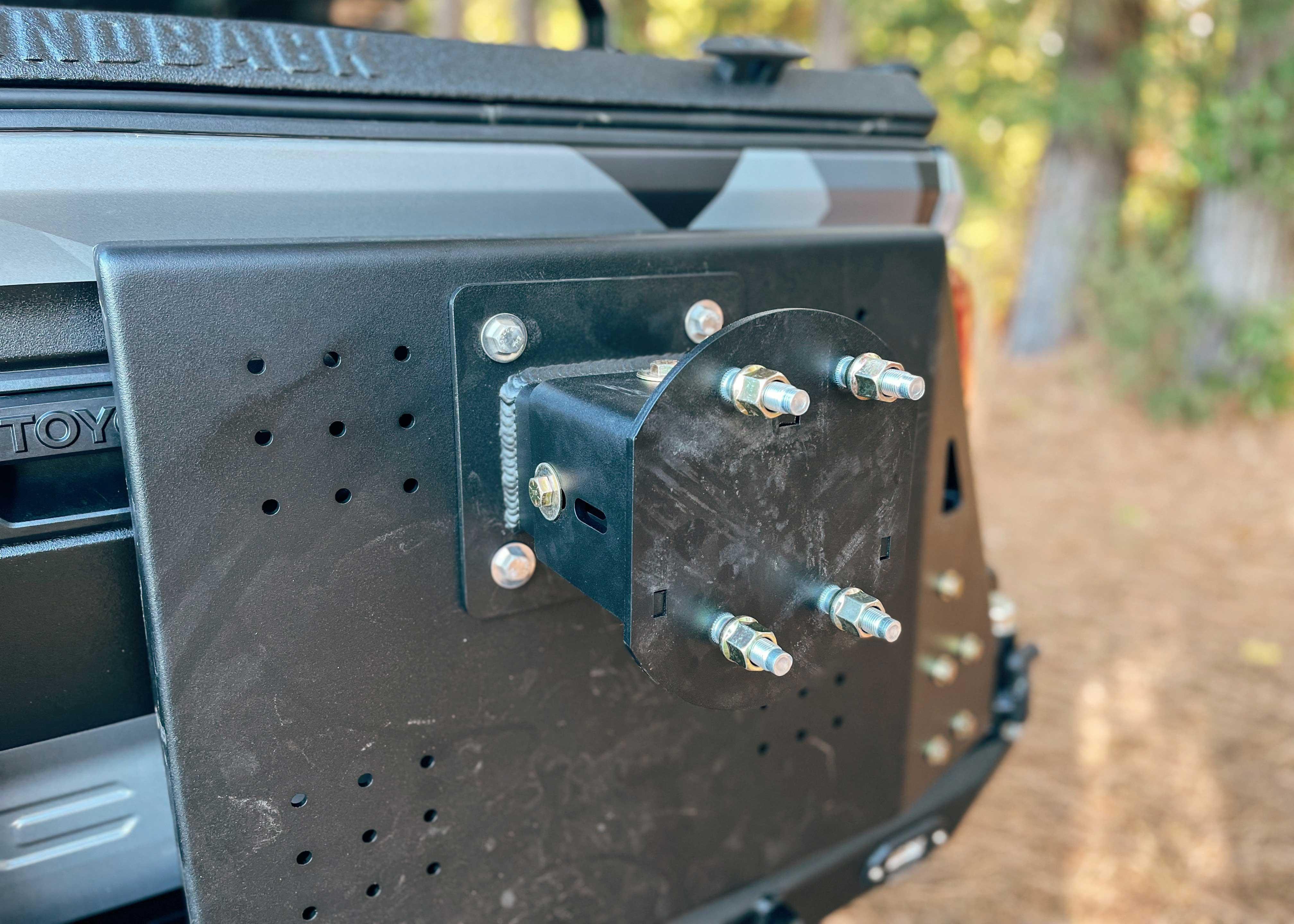 Close up of the spare tire mount on the Backwoods Adventure Mods 2016-2023 3rd Gen Toyota Tacoma Hi-Lite High Clearance Dual Swing Out Rear Bumper 