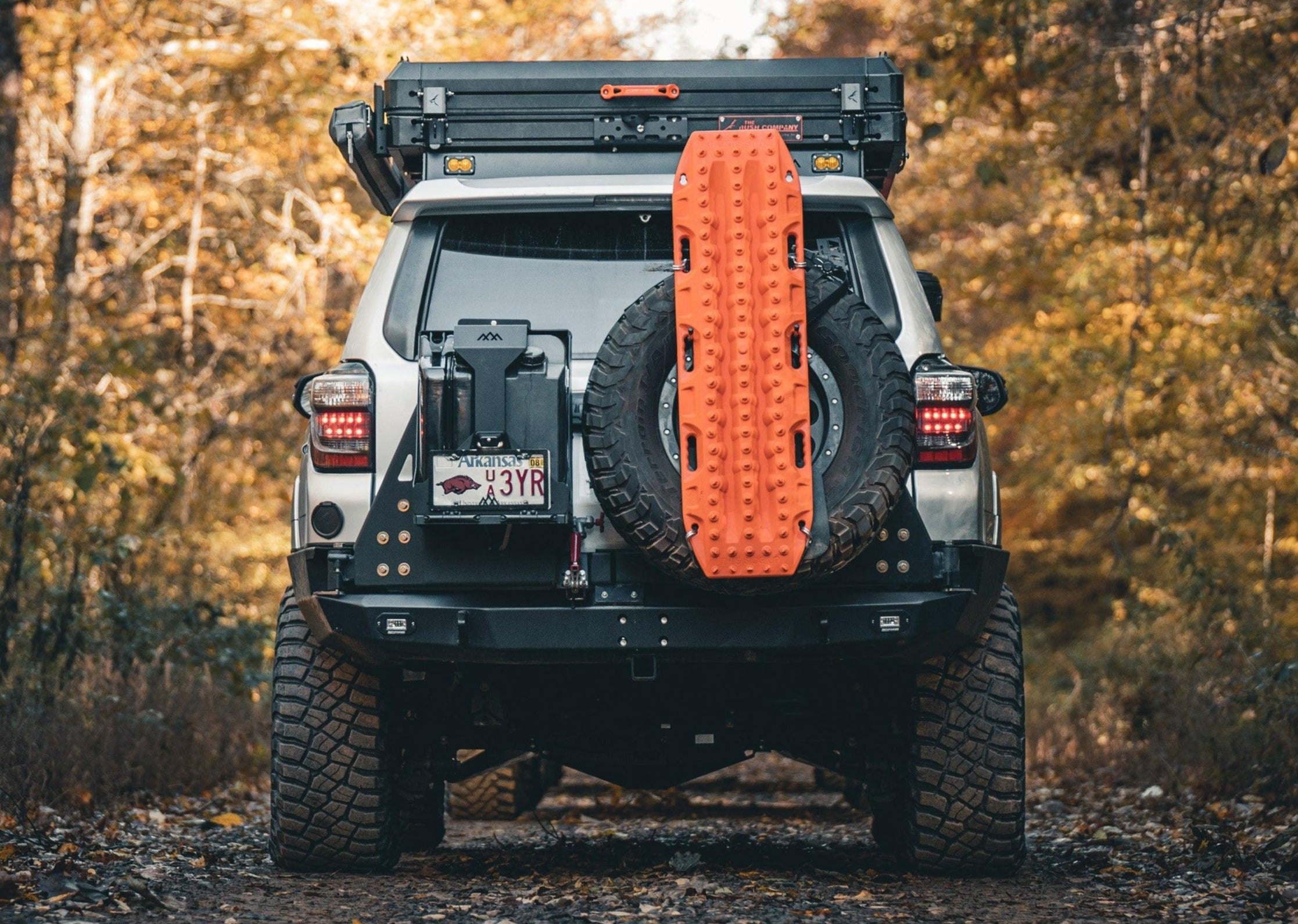 Backwoods Adventure Mods Toyota 4Runner (2014-2022) Hi-Lite High Clearance Dual Swing Out Rear Bumper installed and fitted with spare tire, traction boards, spare fuel tanks, and other off road gear