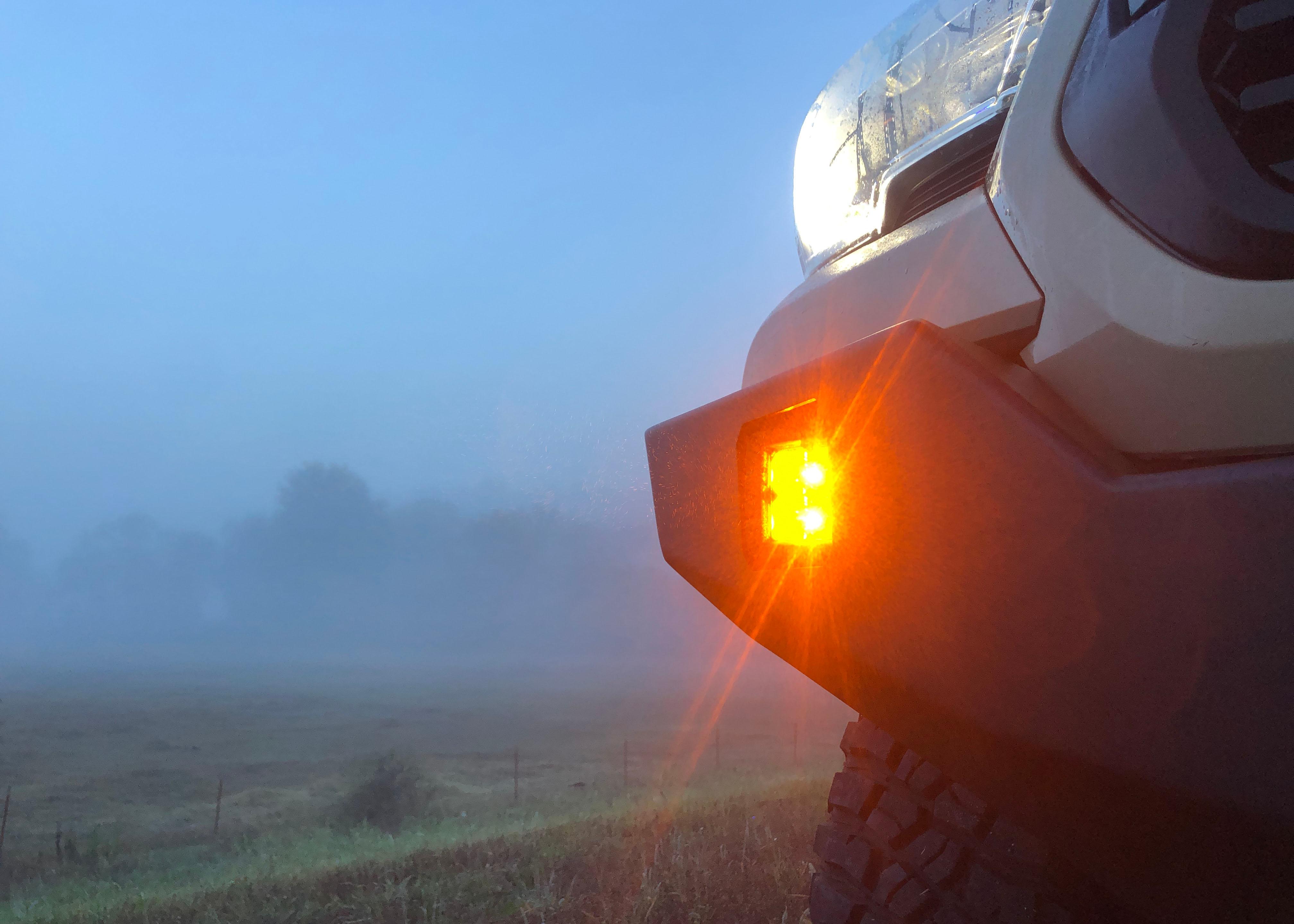 Pathfinder 2 inch Surface Mount Amber LED light pod installed in a Backwoods Adventure Mods Hi-Lite series hybrid Toyota Tacoma off road bumper